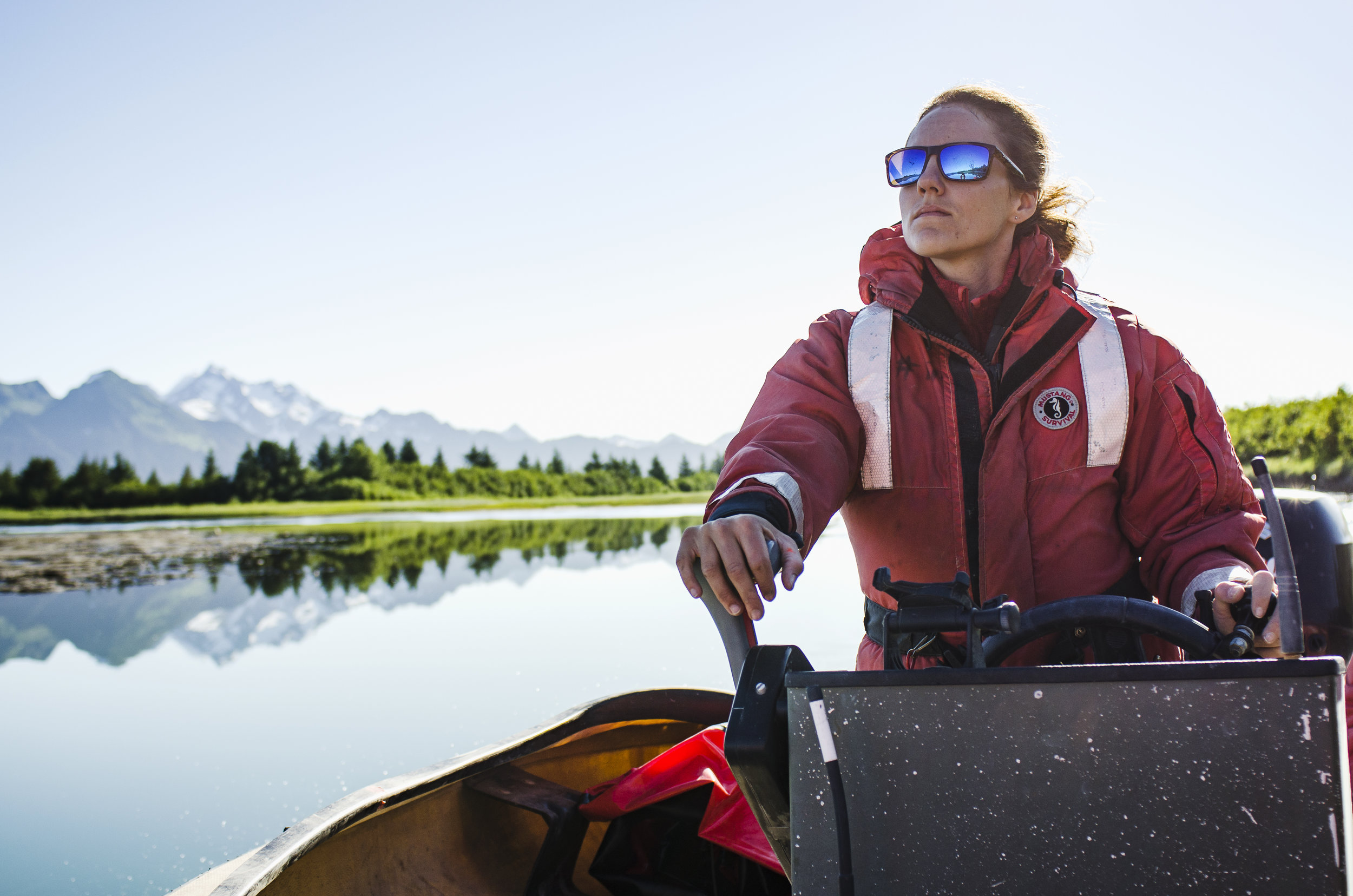  Elizabeth Camarata, a Biological Technician with the United States Forest Service, leads herself and two other female scientists down the Alaganik Slough on the Copper River Delta. The skiff cruise into the delta is the first step in a series of obs