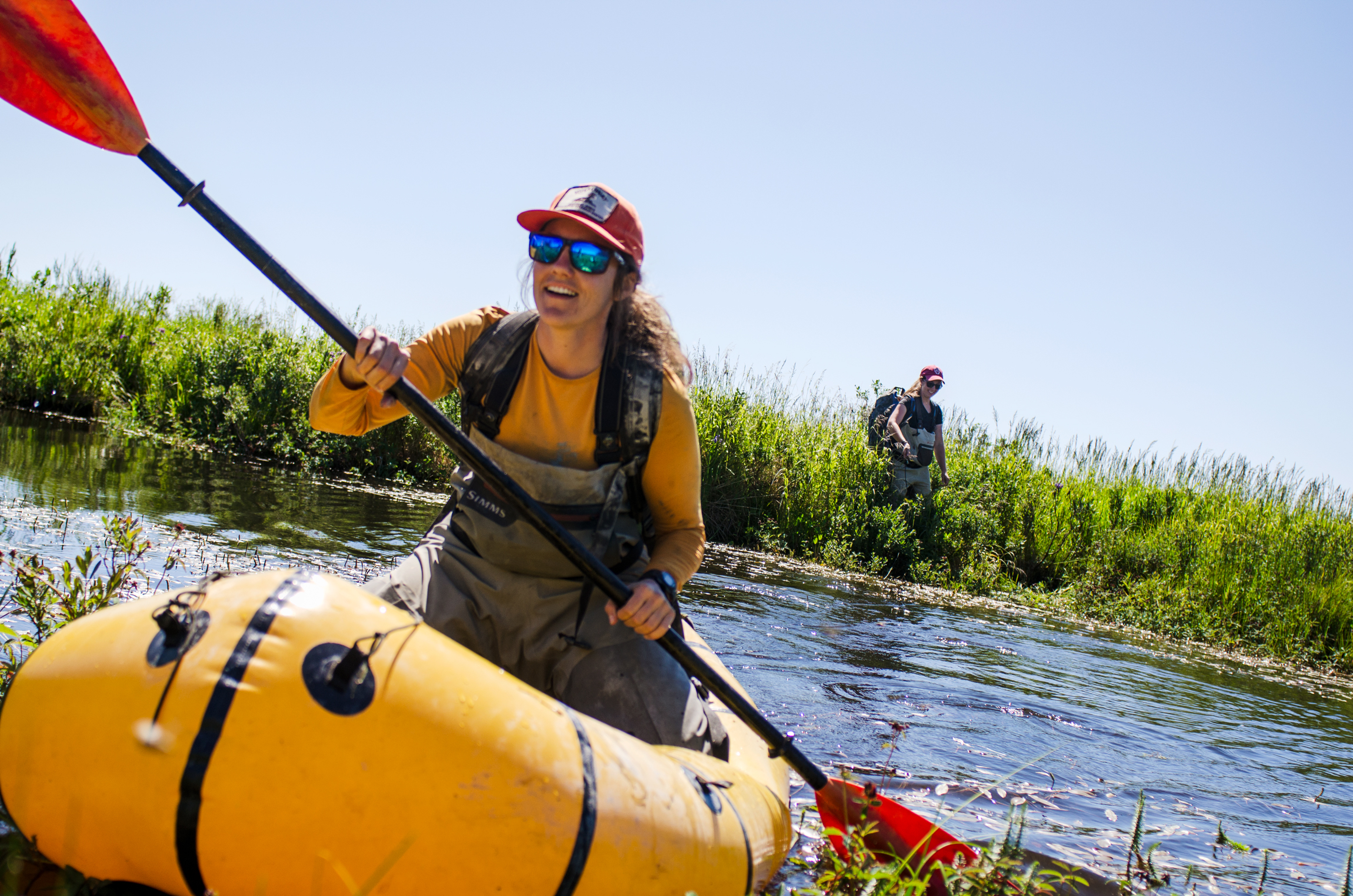  The team uses pack rafts to weave their way through the delta. These inflatable rafts act as handy bridges between ponds, while also keeping the women and their equipment dry. Here, Camarata and her colleague, Amelia McReynolds, tow the raft back an