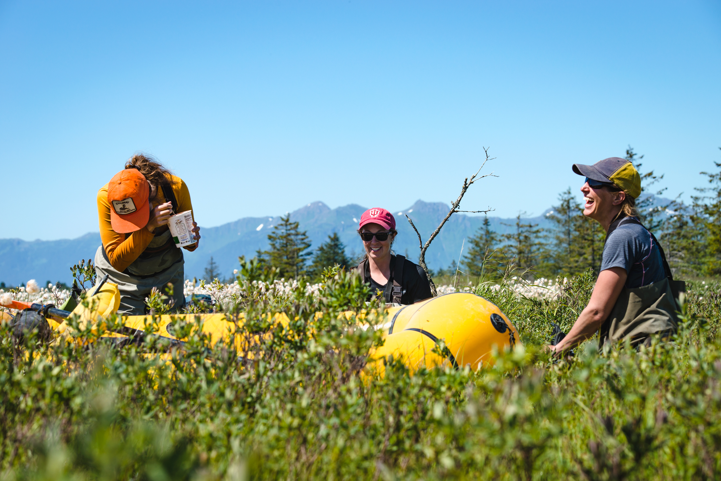  After a long day of trudging through bogs and collecting data, the women grab a snack and share some laughs before making the four mile trudge back to the forest service skiff. 