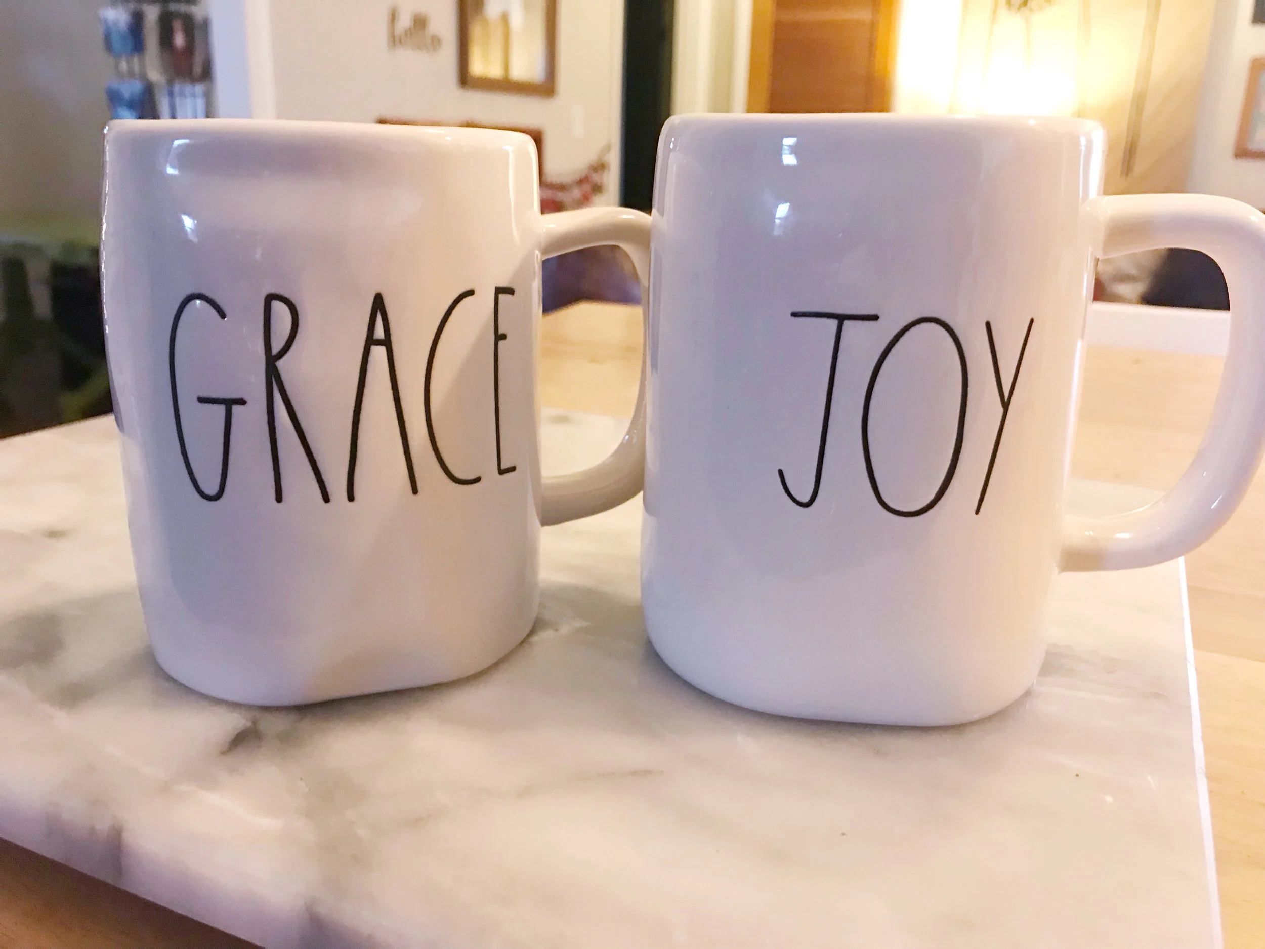 Jen surprised Courtney with these sweet Rae Dunn mugs that have their family's words of 2018!