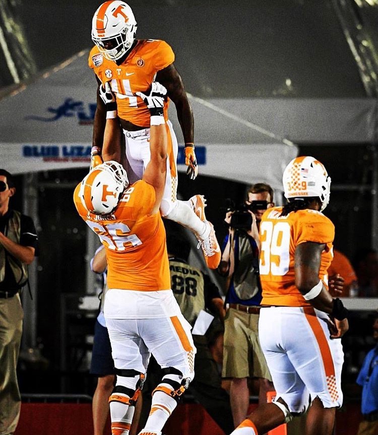 Jack as a UT Football player (the GIANT one lifting up his teammate)