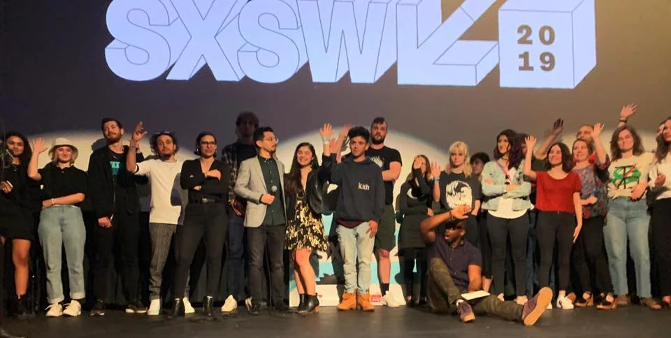 A blurry but beautiful photo of all our students waving on stage at our SXSW 2019 Official Film Showcase
