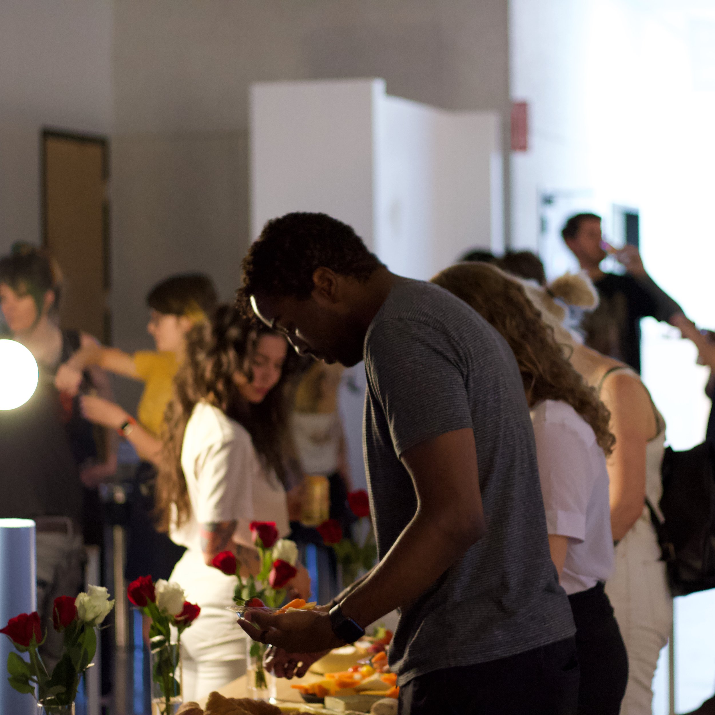 Attendees enjoying food and drinks at the Ophidian premiere.