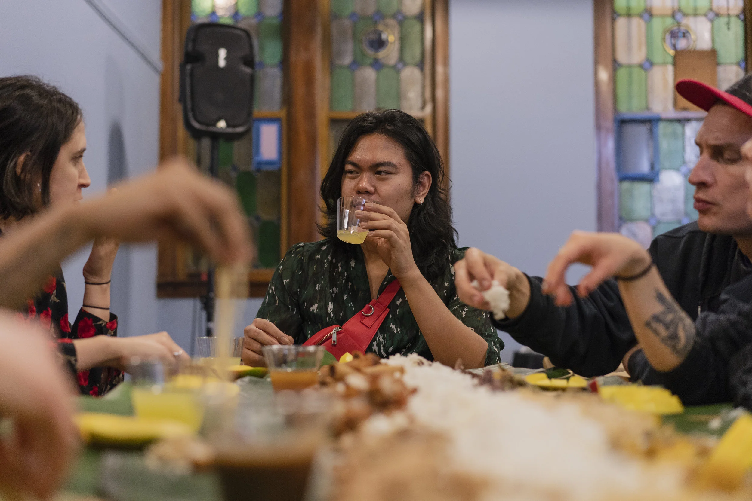 Jerico Domingo chats with attendees. A member of Export Quality Collective was seated at each table to facilitate conversations. Photo By: Pat Nabong