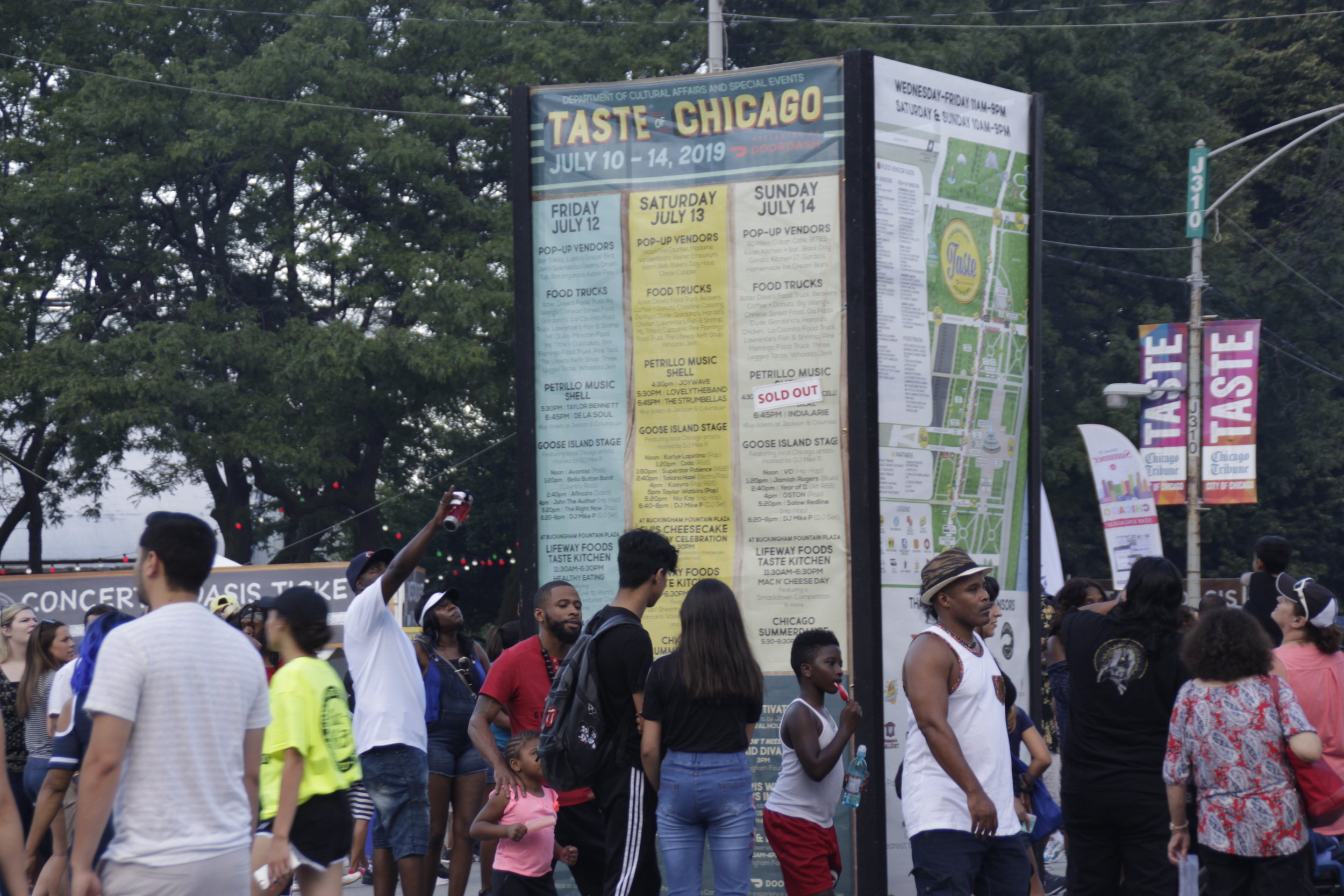  Crowds dispersed on the last day of the 2019 Taste of Chicago as people stopped to look up more information and ask for directions while planning out their day. The display in the middle of the event that served as a map. 