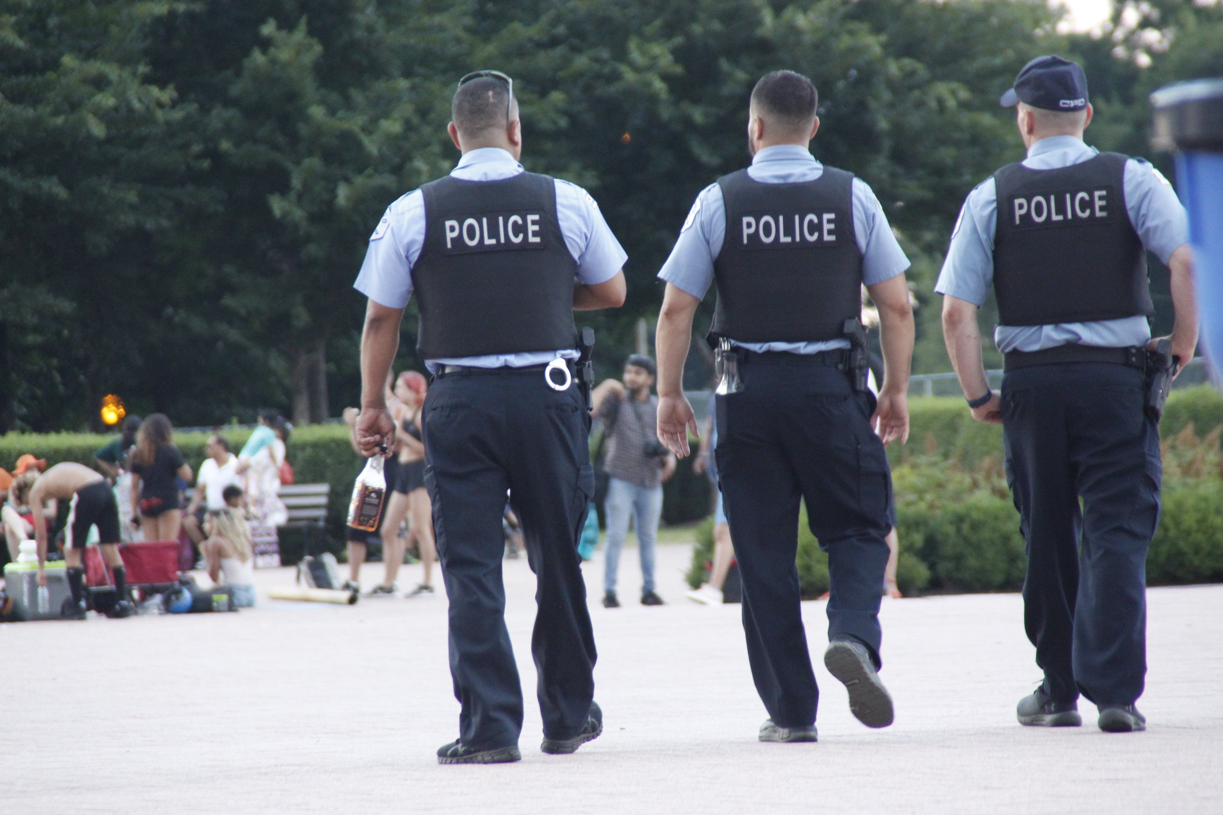  Officers walked around the 2019 Taste of Chicago in groups of three with guns and handcuffs around their waist. Street performers and pedestrians lounged around casually as the officers patrolled. 