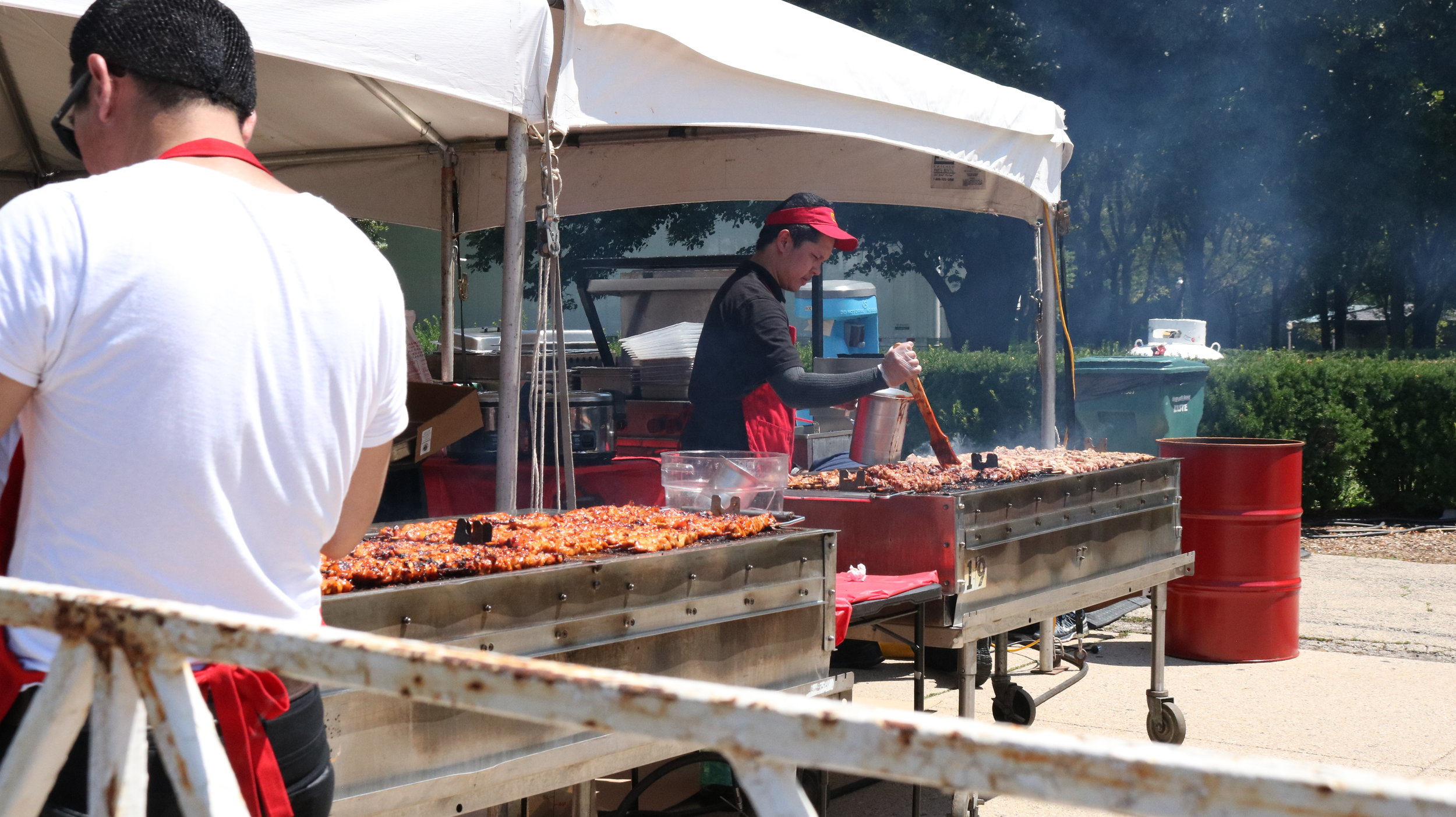  Grill City’s Cook preparing Chicken BBQ on Stick during the first day of the Taste of Chicago. Photo by Clariza Adao  