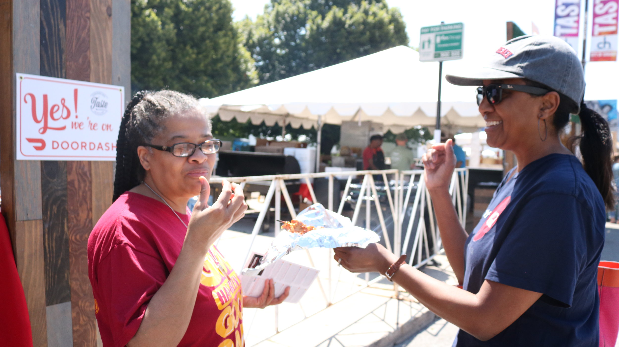  Two first-timers at Grill City sampling the Pork BBQ on a stick. Photo by Clariza Adao 