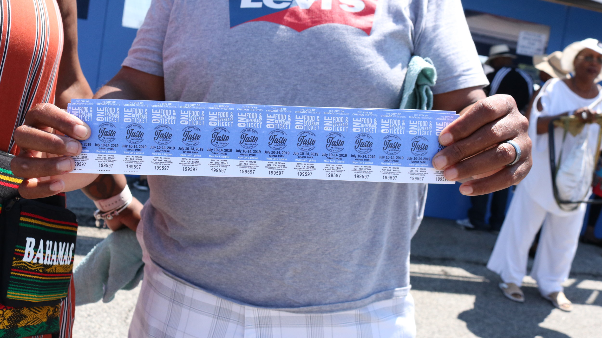  An attendee presenting his tickets at the Taste of Chicago. Photo by Clariza Adao 