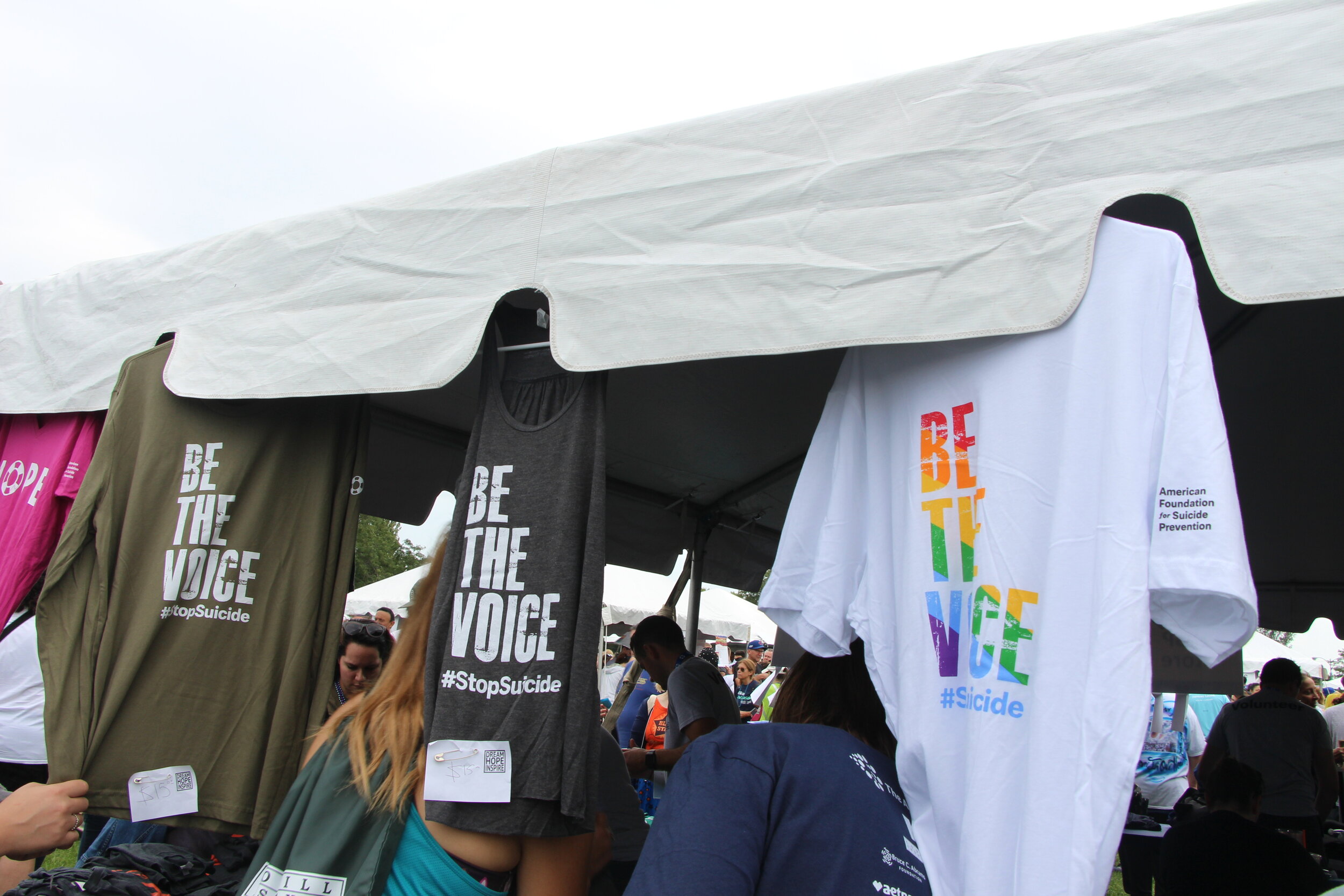 T-shirts with “Be the Voice” motifs for sale at the merchandise tents.