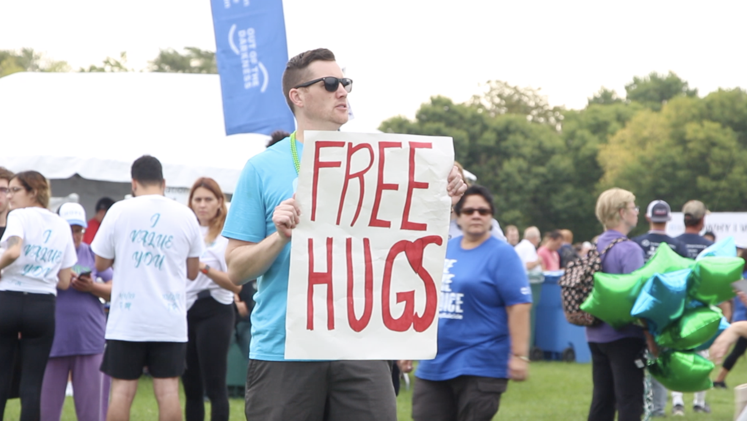 A volunteer offering free hugs at the event.