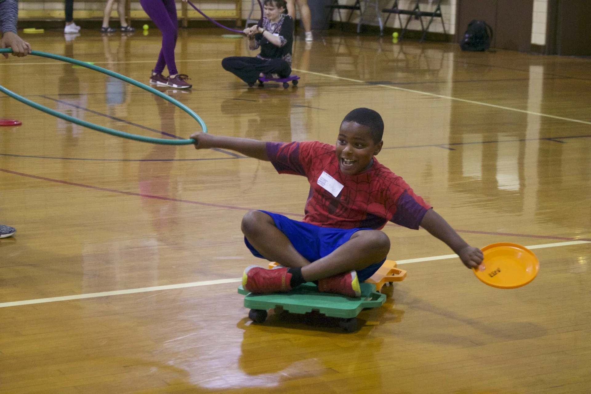 A KEEN athlete enjoys playtime with a volunteer during the KEEN Sports program at Loyola Park.