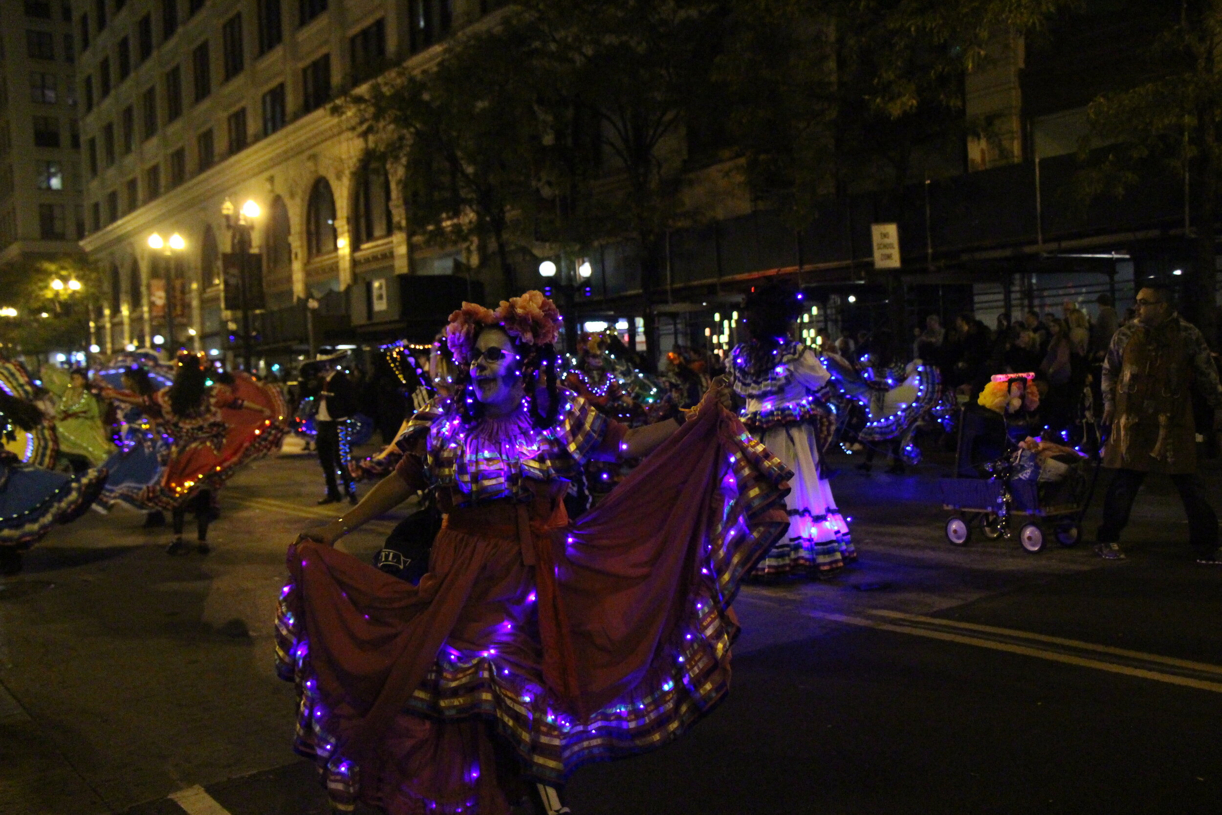 Performers twirling their way across the Art in the Dark parade