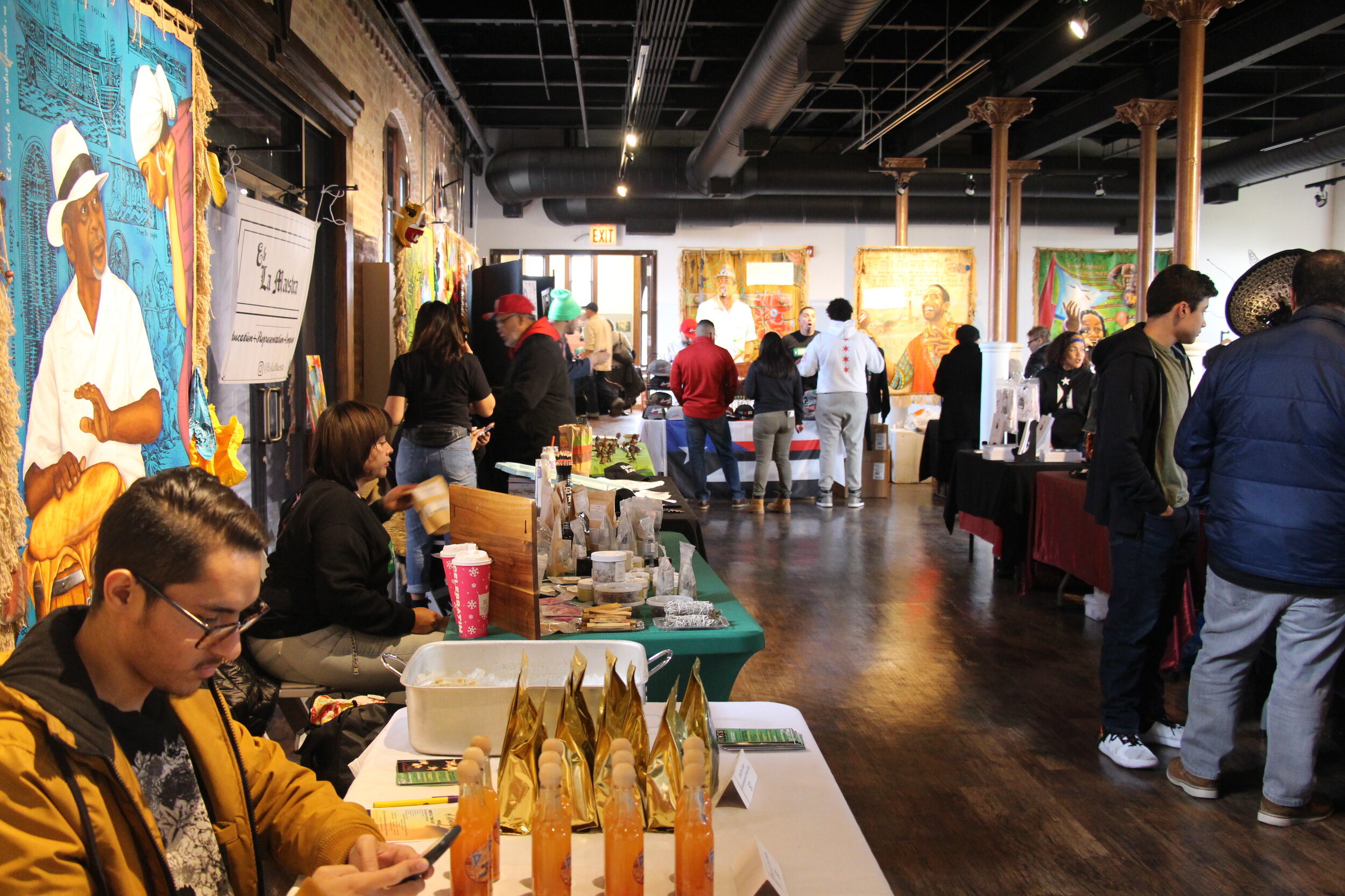  All under one roof. The walls were filled with artwork from Puerto Rican, black and brown artists. People mixed and mingled while shopping for the holidays. 