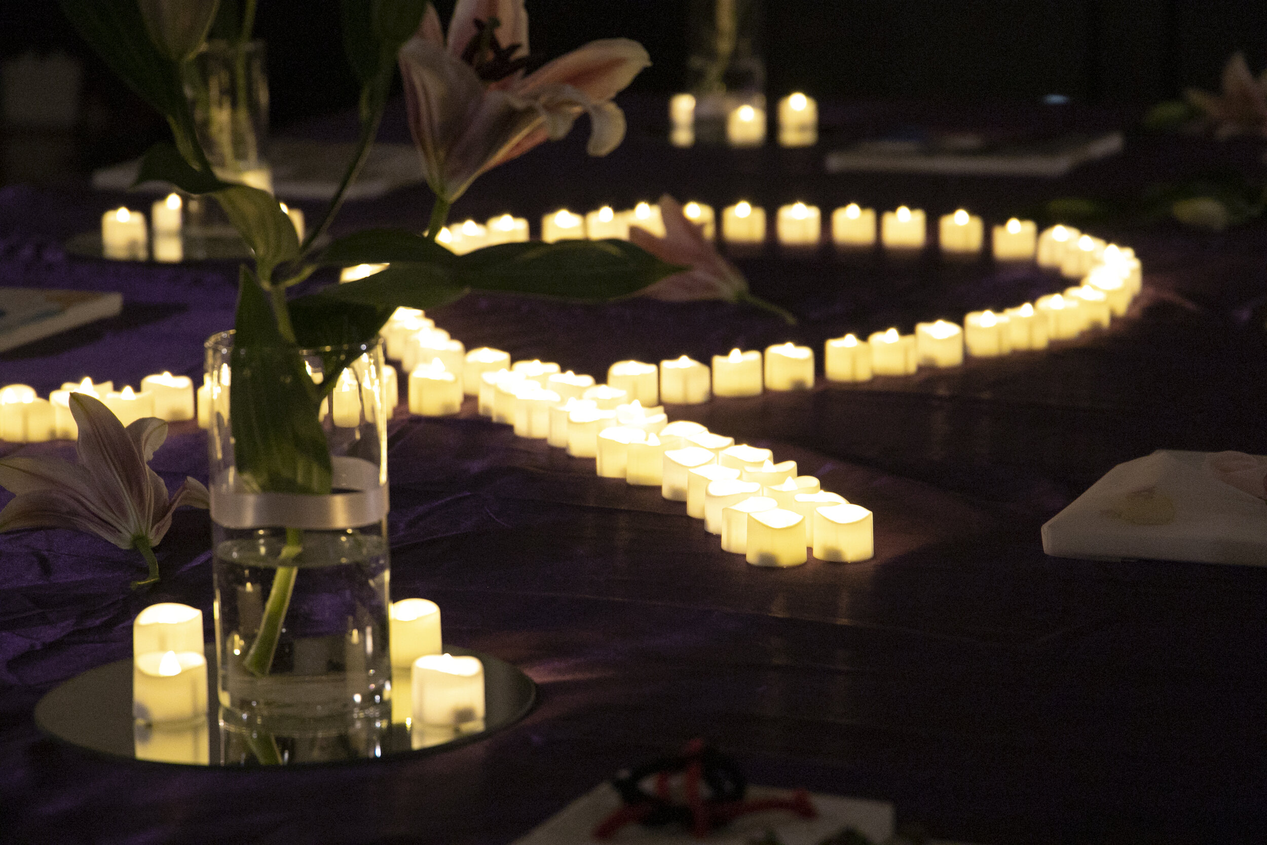  Candles are lighted in memory of the victim at the event and also to raise awareness of domestic violence. Photo by Carolyn Chen 