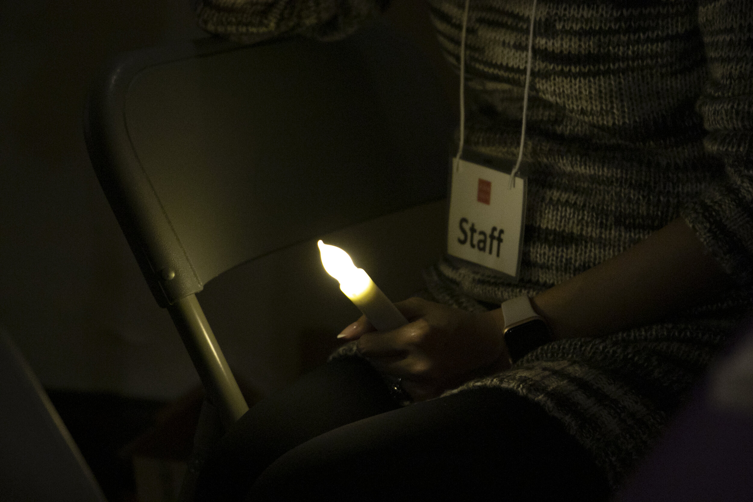  A staff member held a candle at the event. Photo by Carolyn Chen 