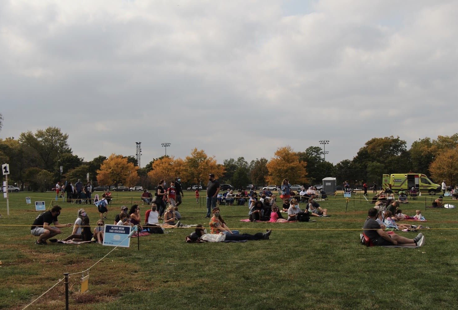  The audience is sitting in the grass, waiting for the performance to begin while following the safety precaution by staying a social distance apart at Park No. 218. (Photo taken by Sabrina Hart)    