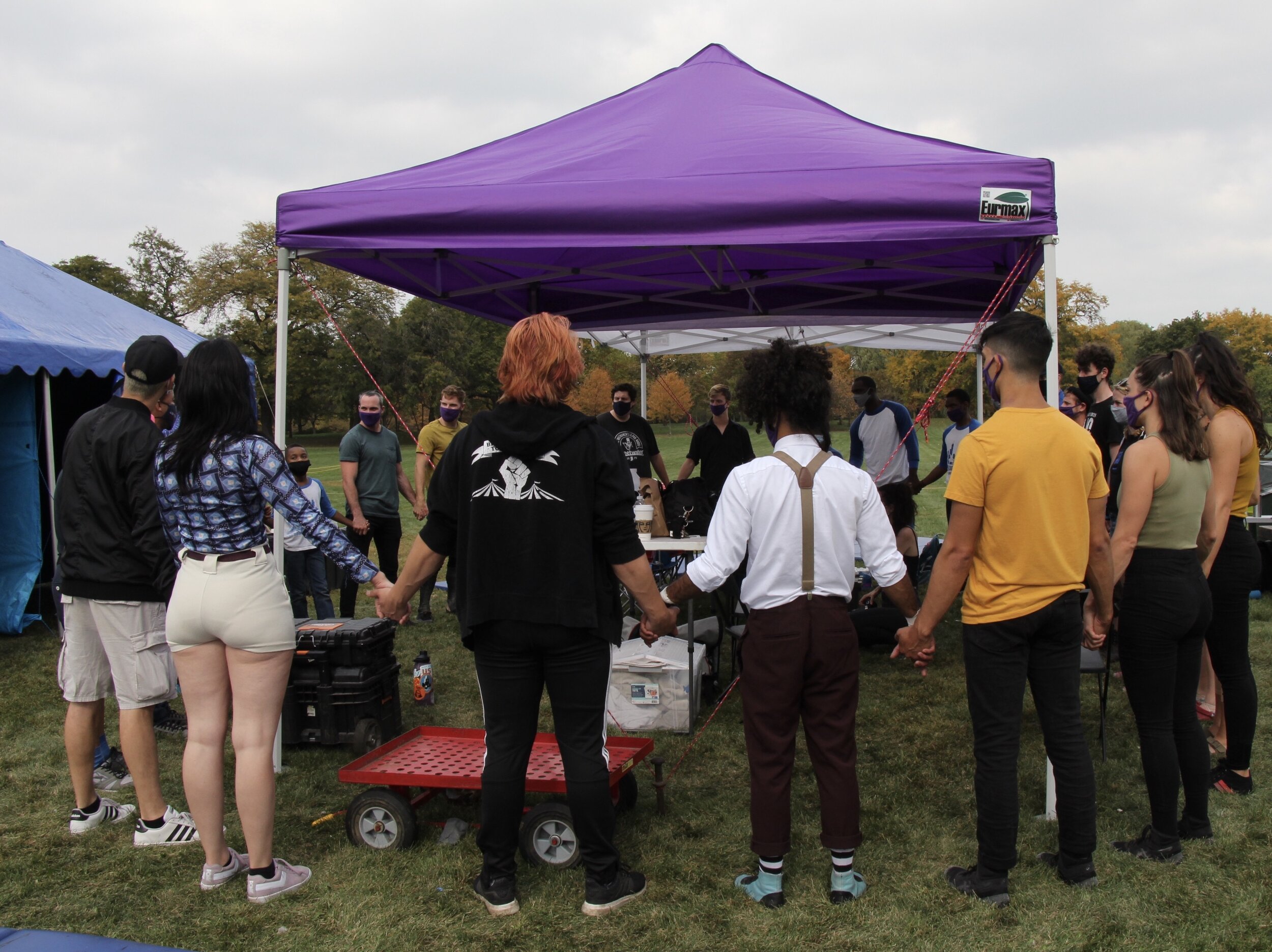  The performers and the creative team hold hands and chants before they go on stage. (Photo taken by Sabrina Hart)    