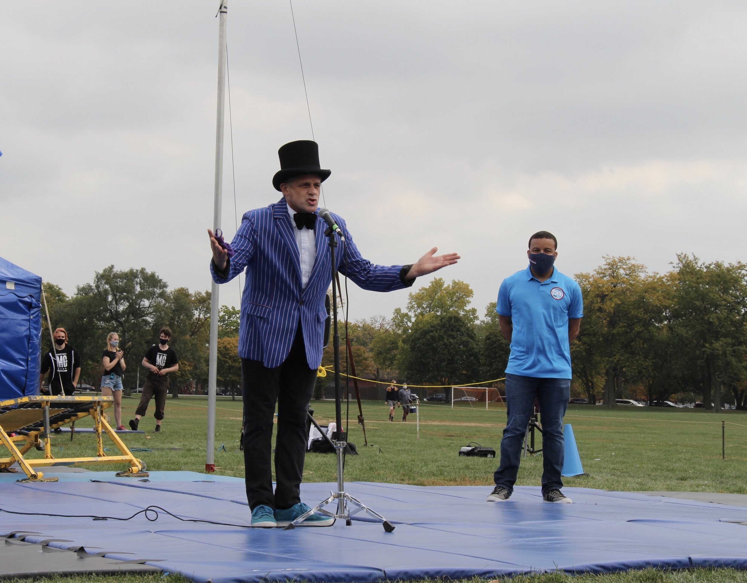  Jeff Jenkins(left), the Founder/Directors of Midnight Circus In the Parks wearing a blue and white suit, introduces his organization and the Ald. Michael Scott, Jr. (24th Ward) standing behind him, Michael Scott Jr.(right) (Photo taken by Sabrina Ha