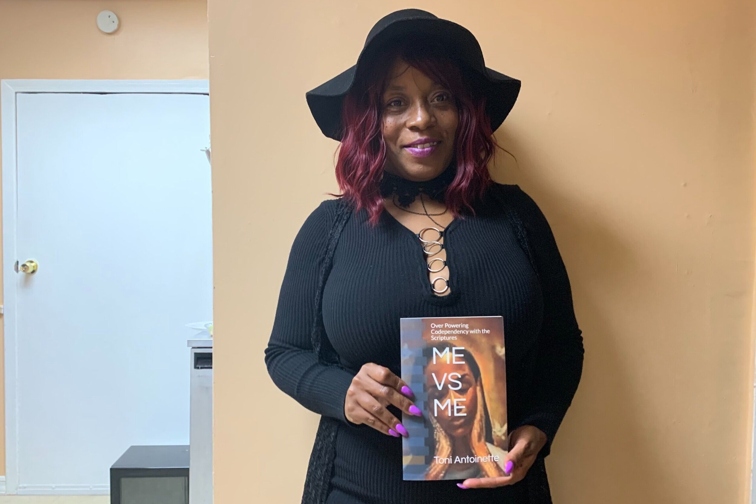   Toni Garrett  presents a free verse poem entitled "From Darkness to the Light" at the Colour Me Bad Artistry art gallery. The photo was taken by Sabrina Hart.  “I'm presenting [the poem] because I'm a God-fearing woman, I believe, and I'm also abou