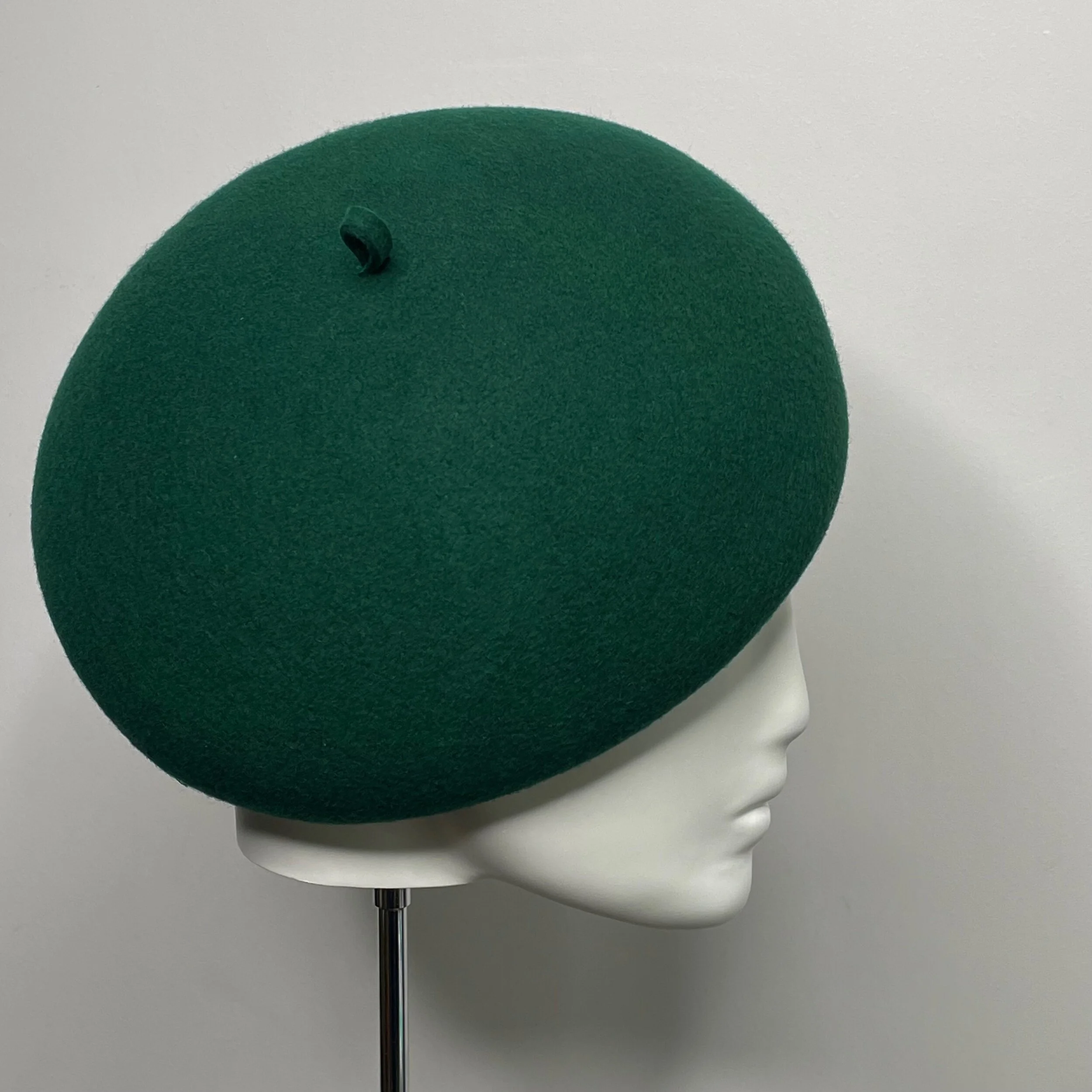 Handmade millinery in forest  green felt