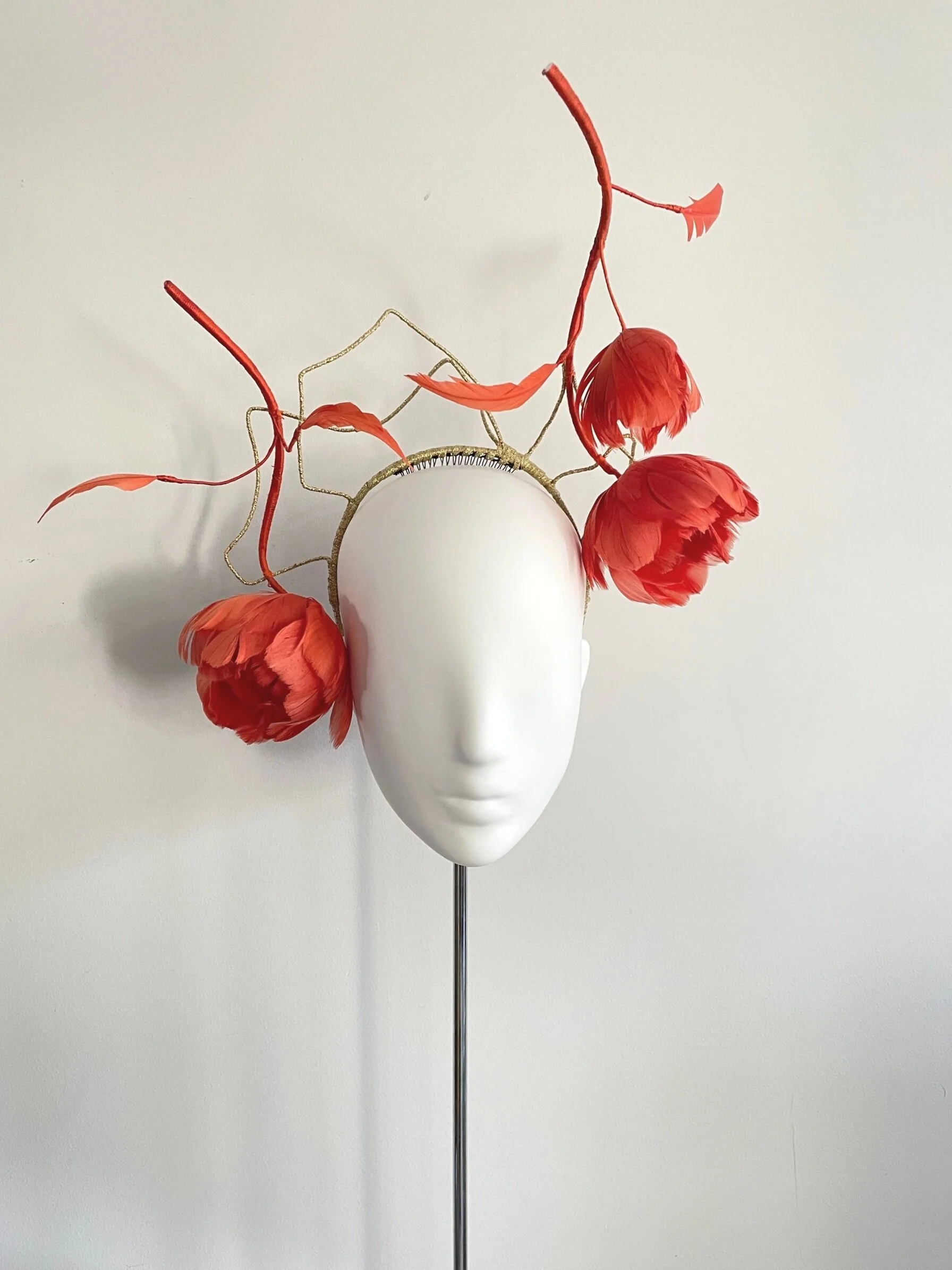 Hand sculpted feather roses for a fashion hat
