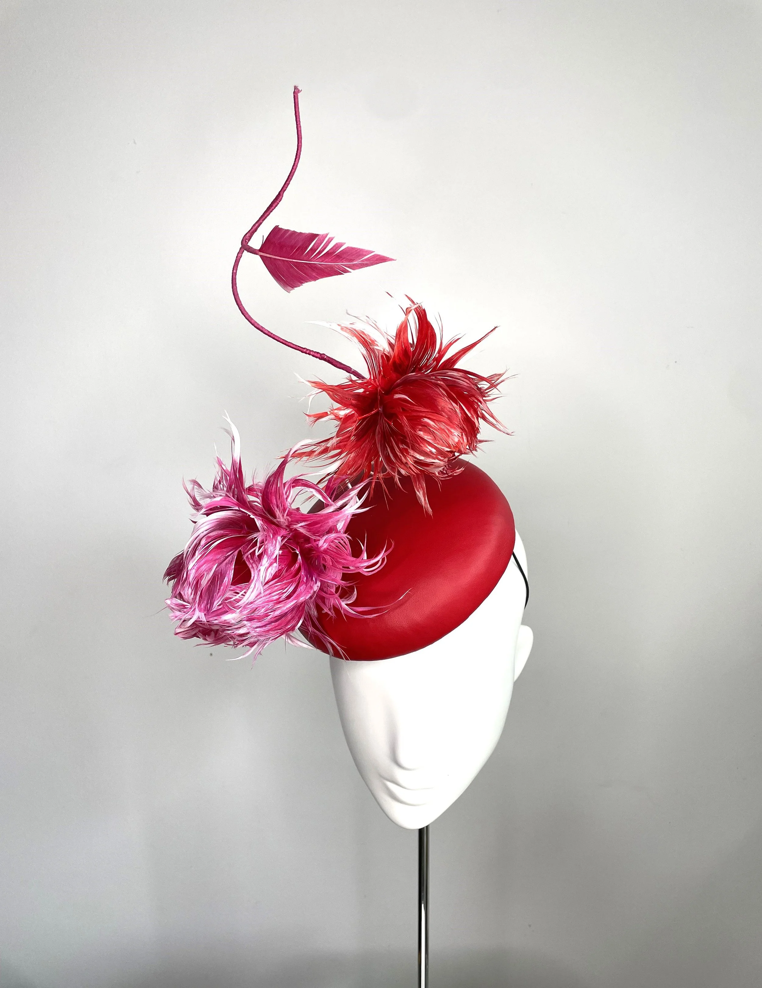 Discover elegance with our Pop Lume-Leather button shaped hat from Rachel Henry Millinery. Handcrafted with exquisite detail,  Shop our hats now for timeless style.