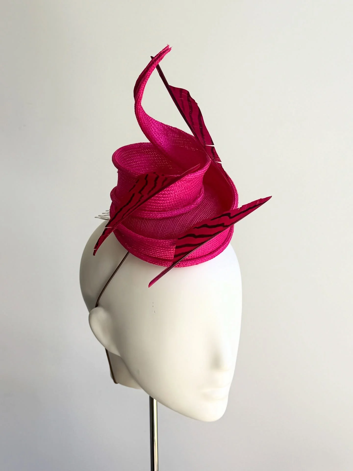 You have to love the colour that spring brings. 
This hat is for Penny. 

This a mini button hat. A matching bright pink straw twist with a handrolled edge and floating feathers. Penny saw a yellow version of this hat and loved it, unfortunately the 