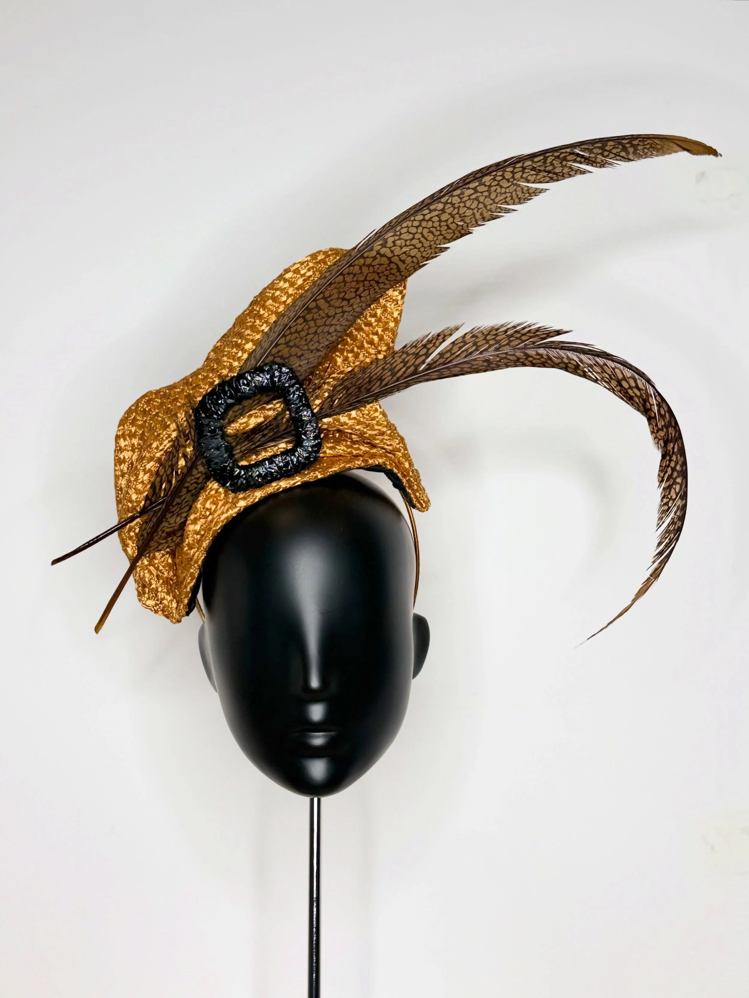 Designed and made for the modern woman who values uniqueness.This bespoke headpiece features freehand sculpted straw cloth touqe and dramatic pheasant tail feathers. 
#millinery #hats #fashion