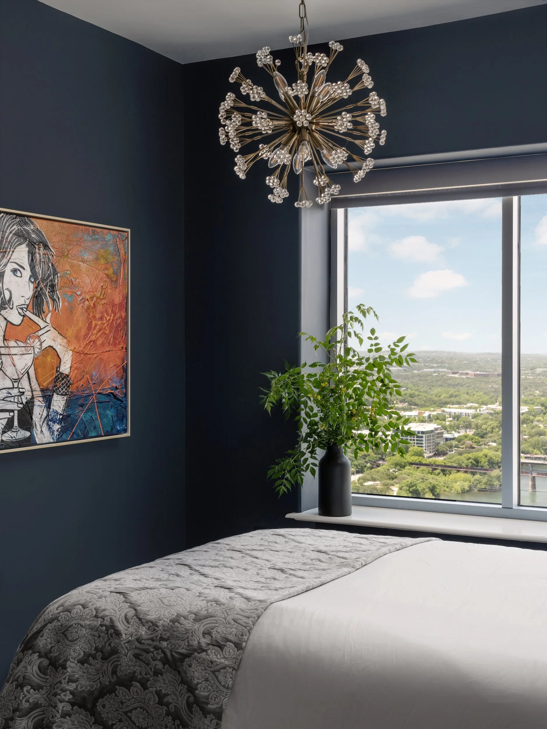 Navy condo bedroom with sputnik chandelier and city view, Breathe Design Studio