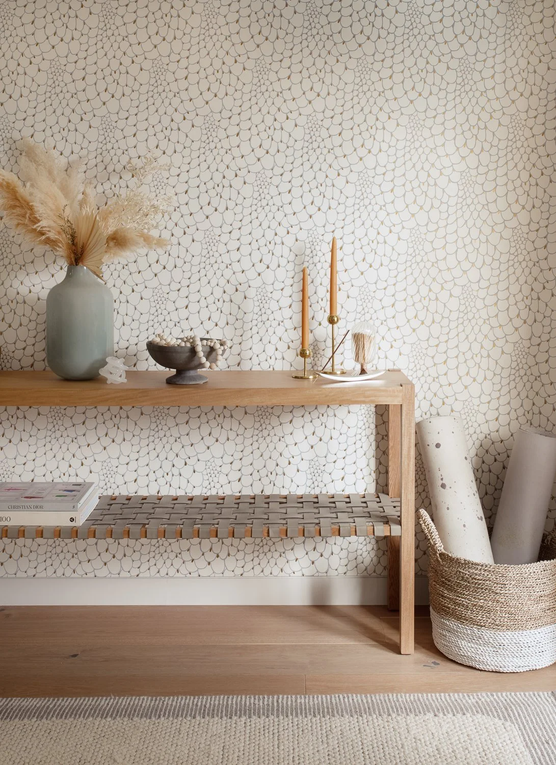 Woven bench against textured wallpaper with pampas vase, Breathe Design Studio