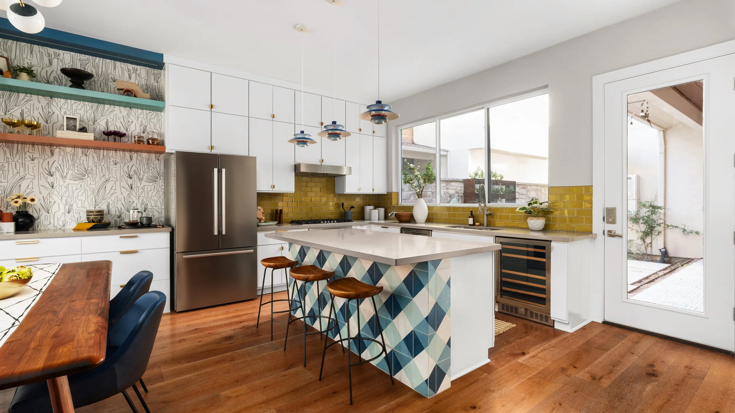 Open kitchen with patterned tile island and wood floors, Breathe Design Studio