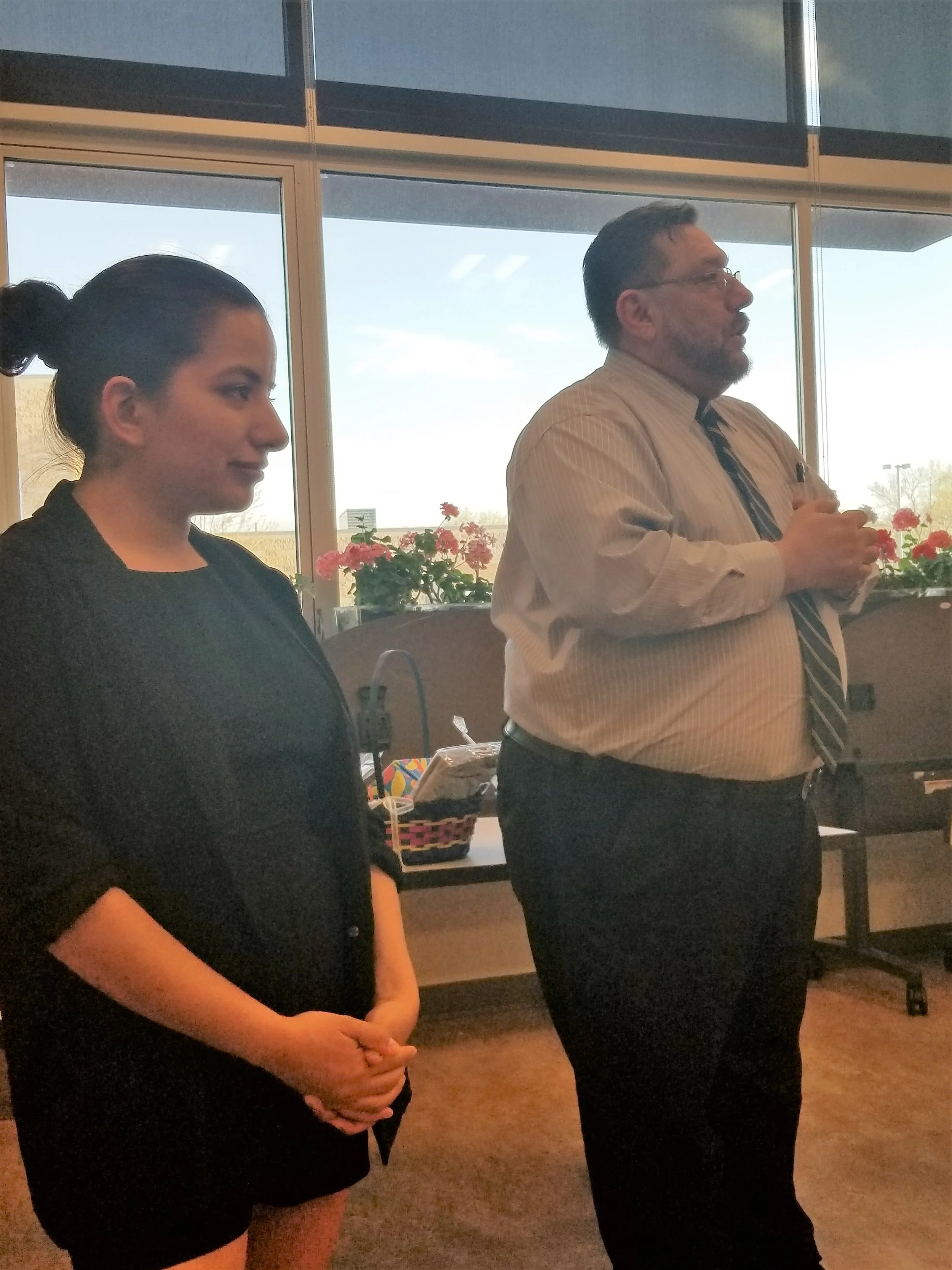 Program facilitators Stephany Murguia-Vega from the Rape Recovery Center and Javier Campos from Centro de la Familia de Utah offering congratulations to the families graduating from the 8 week Nuestras Familias, Nuestra Salud program. 