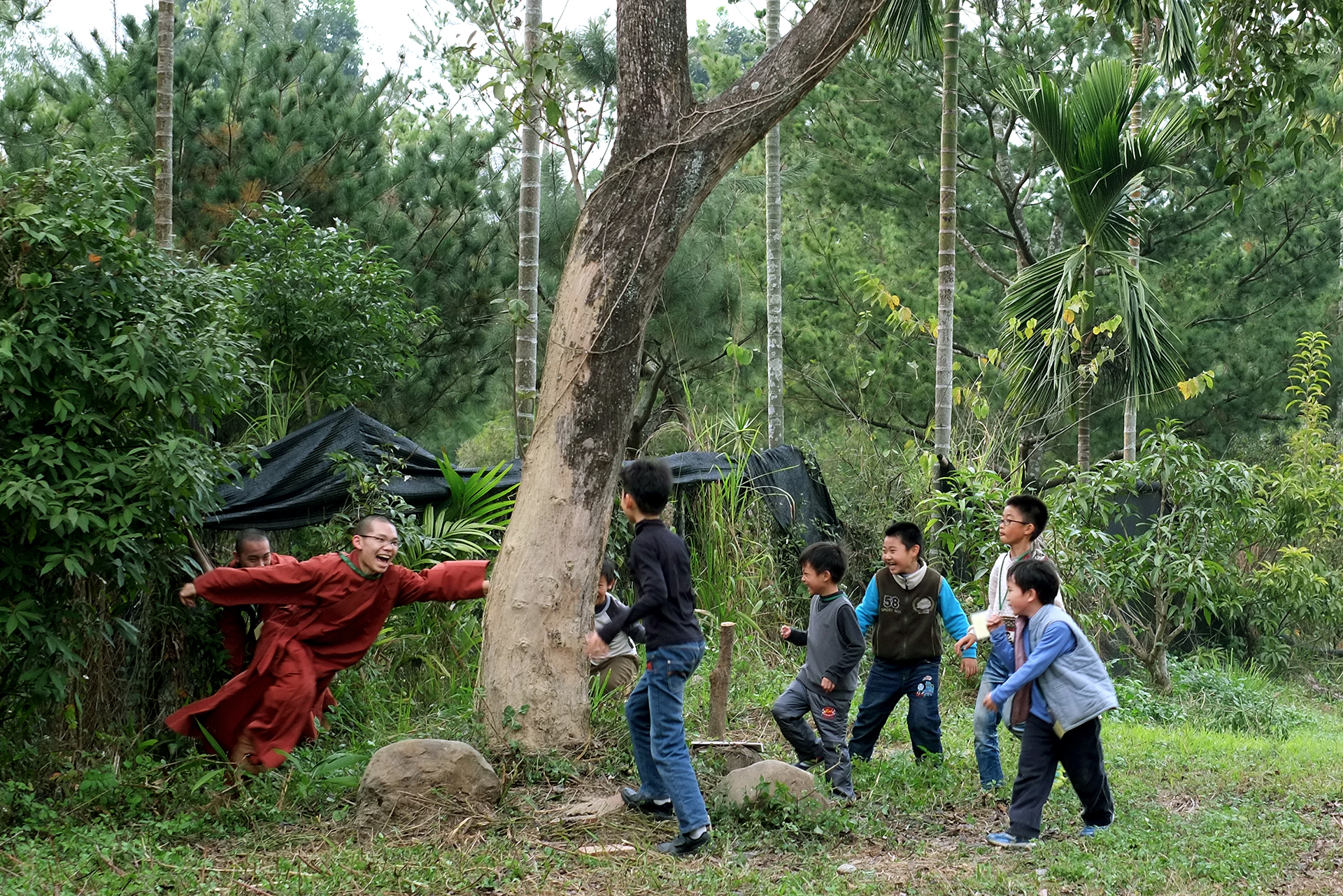 Two young monks play chasing game with six kids, Gukeng, Yunlin, Taiwan