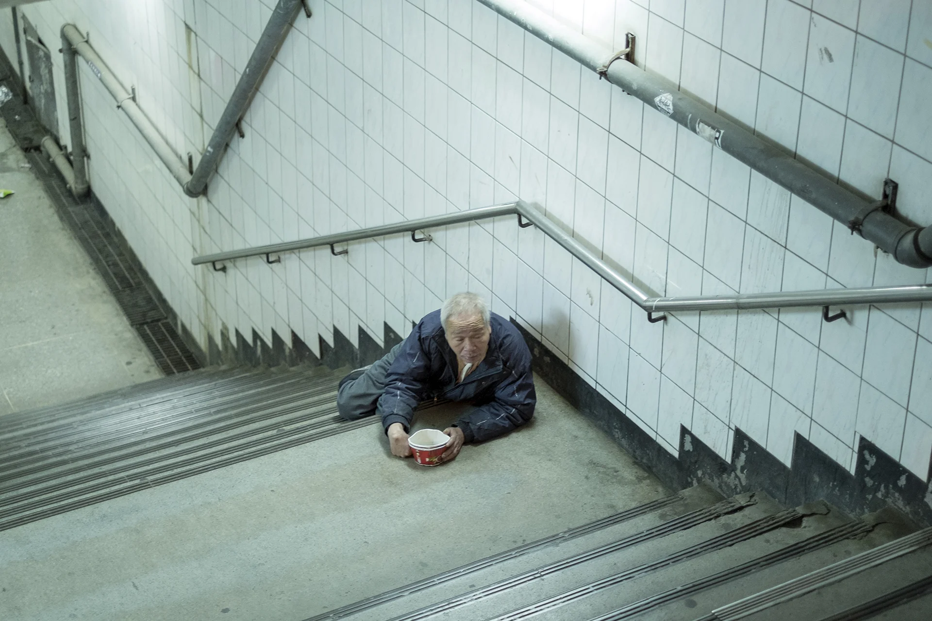 The beggar lying at the pedestrian underpass, Taoyuan, Taiwan