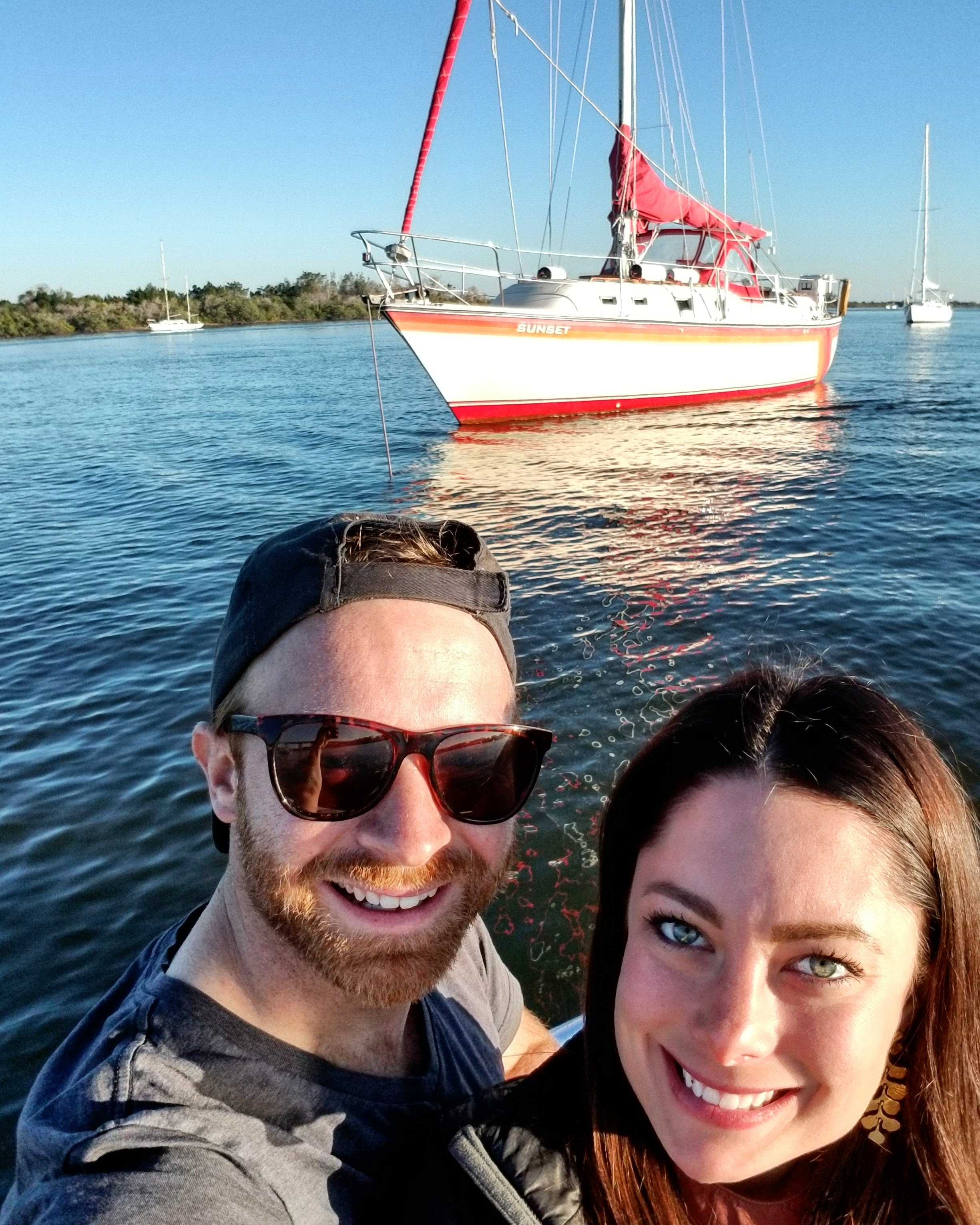 Kelsey and I motoring to shore for New Year's Eve with Sunset in the background.