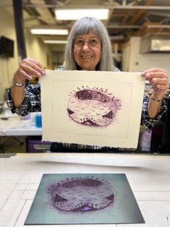 kathleen smith with her print of a basket, pomo elder.jpg