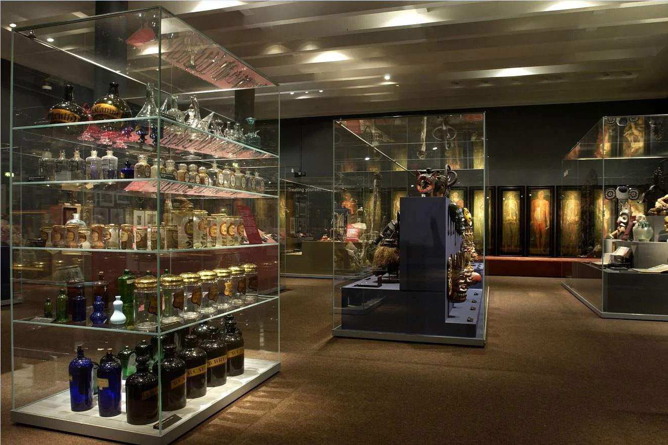 An exhibition with two large display cases filled with objects.
