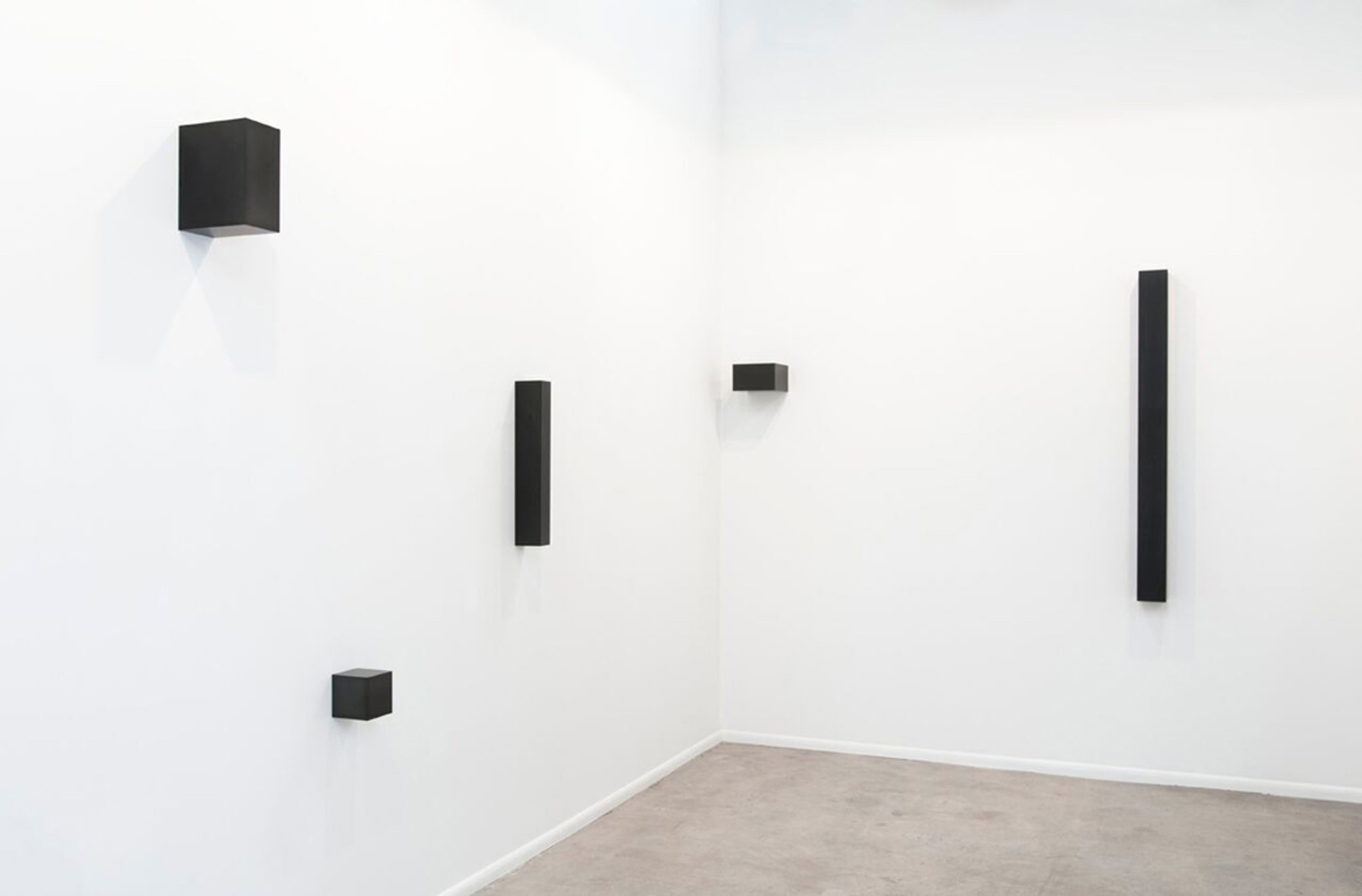  Graphite Sculptures (l to r), Askew Cube, 2011, 7.5” x 7.6” x 7.6”; Cube, 2015, 5.1” x 5.1” x 5.1”; Vertical Bar, 2009, 24.25” x 3.25” x 4.25”;  Golden Mean Horizontal, 2015, 5.4” x 8.9” x 8.9”; Untitled (Column), 2015, 3” x 3” x 70” 