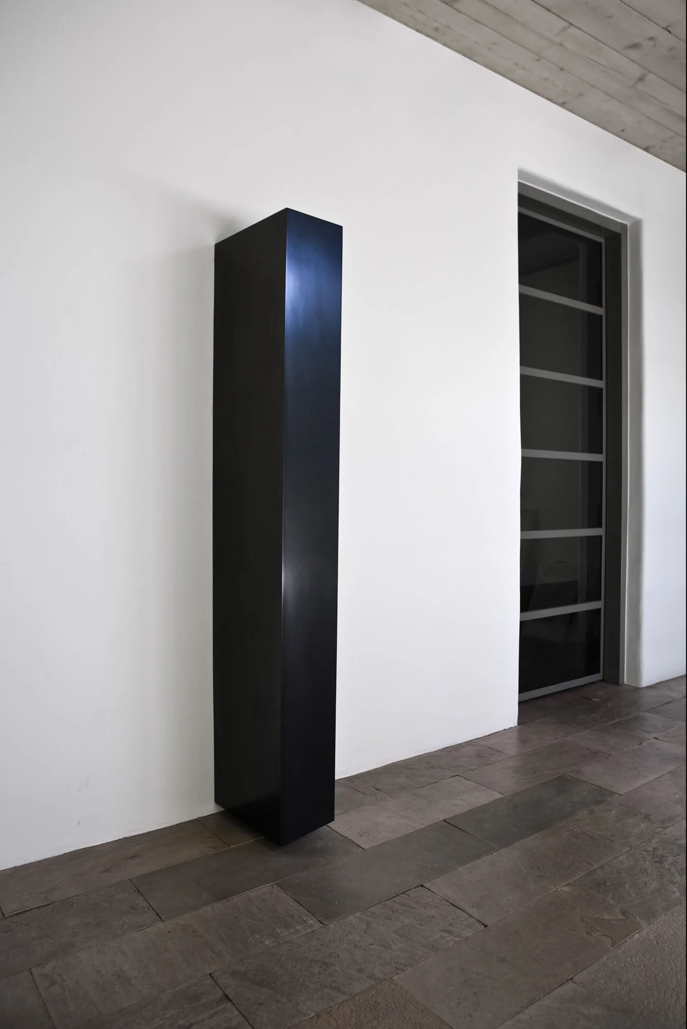Tiltled Column, 2008 Solid Graphite, 70” x 14” x 15” Photo: Jamey Stillings; courtesy of Lannan Foundation