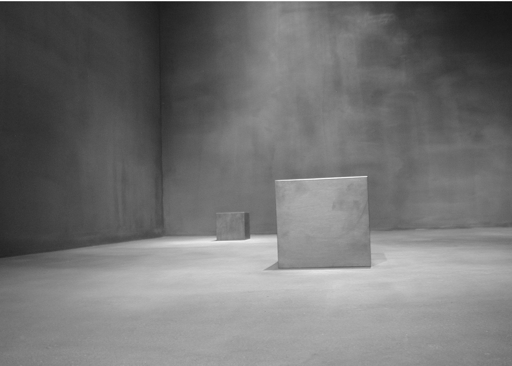   Center of Gravity (installation detail view, School of the Art Institute of Chicago, 2004)   Rectilinear Solid (foreground), 2004, Solid graphite,&nbsp;18” x 12” x 12”  Panza Collection 