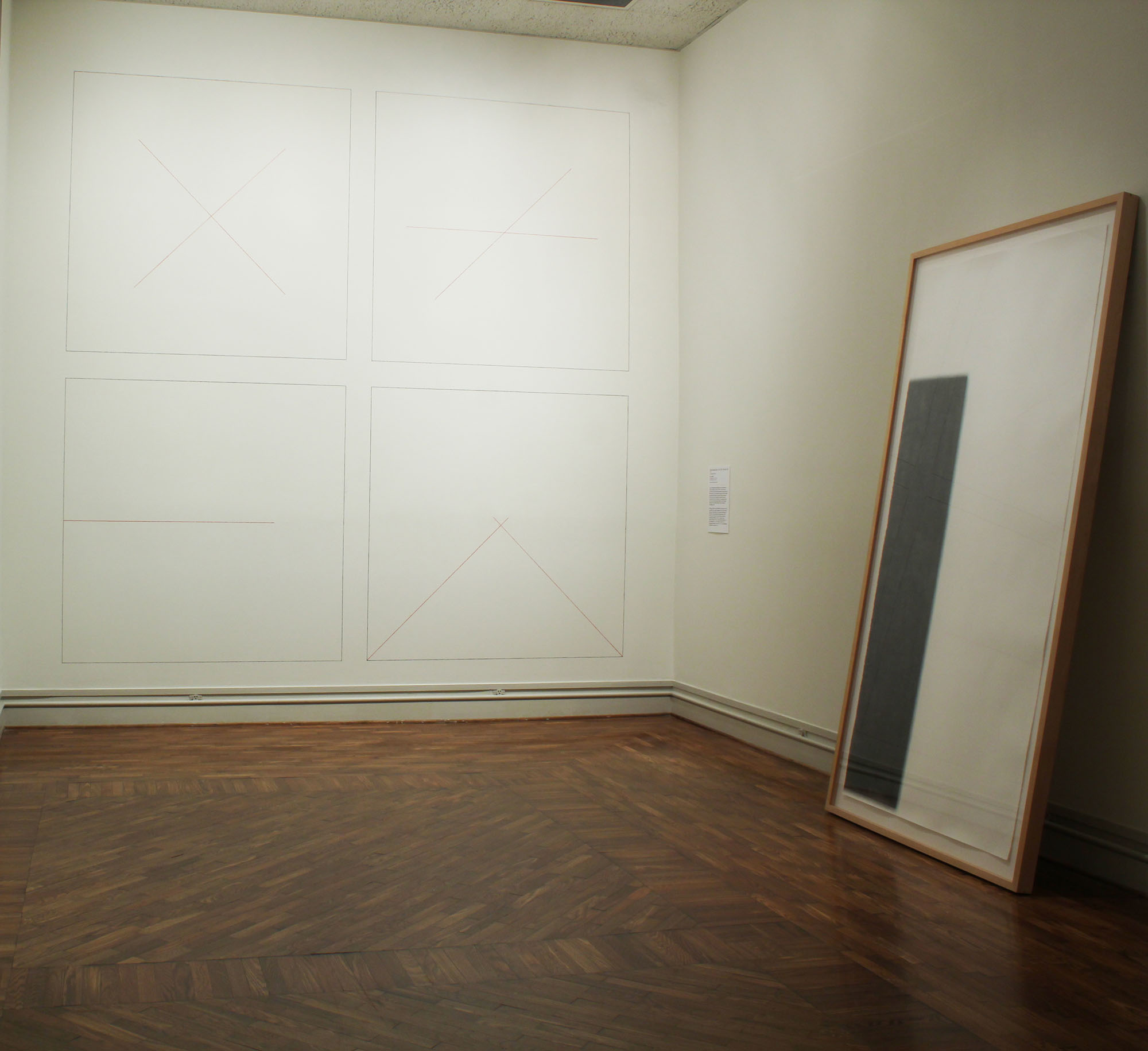   Beyond the Grid/ Into the Sublime, A New View on Minimalism (installation view, 2014)  Susan York, Tilted Column (right), 2008, graphite pencil on paper,&nbsp;8’ x 4’ x 2” (framed)  Sol LeWitt,  Wall Drawing series (left) 