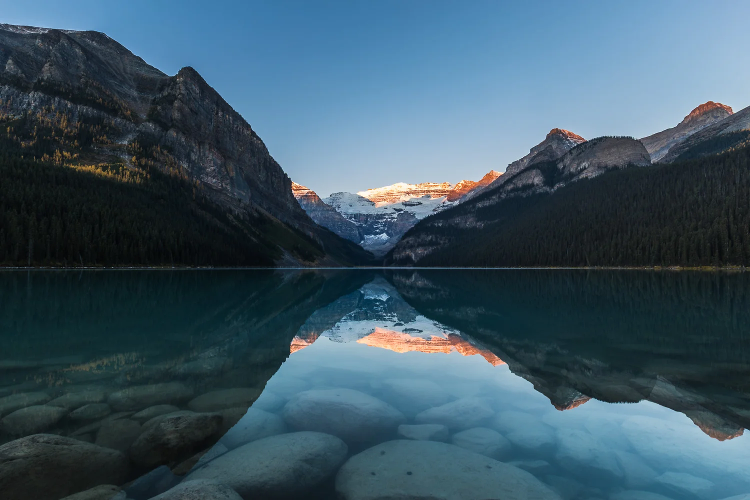 Here comes the sun, lighting up the peaks above Victoria glacier