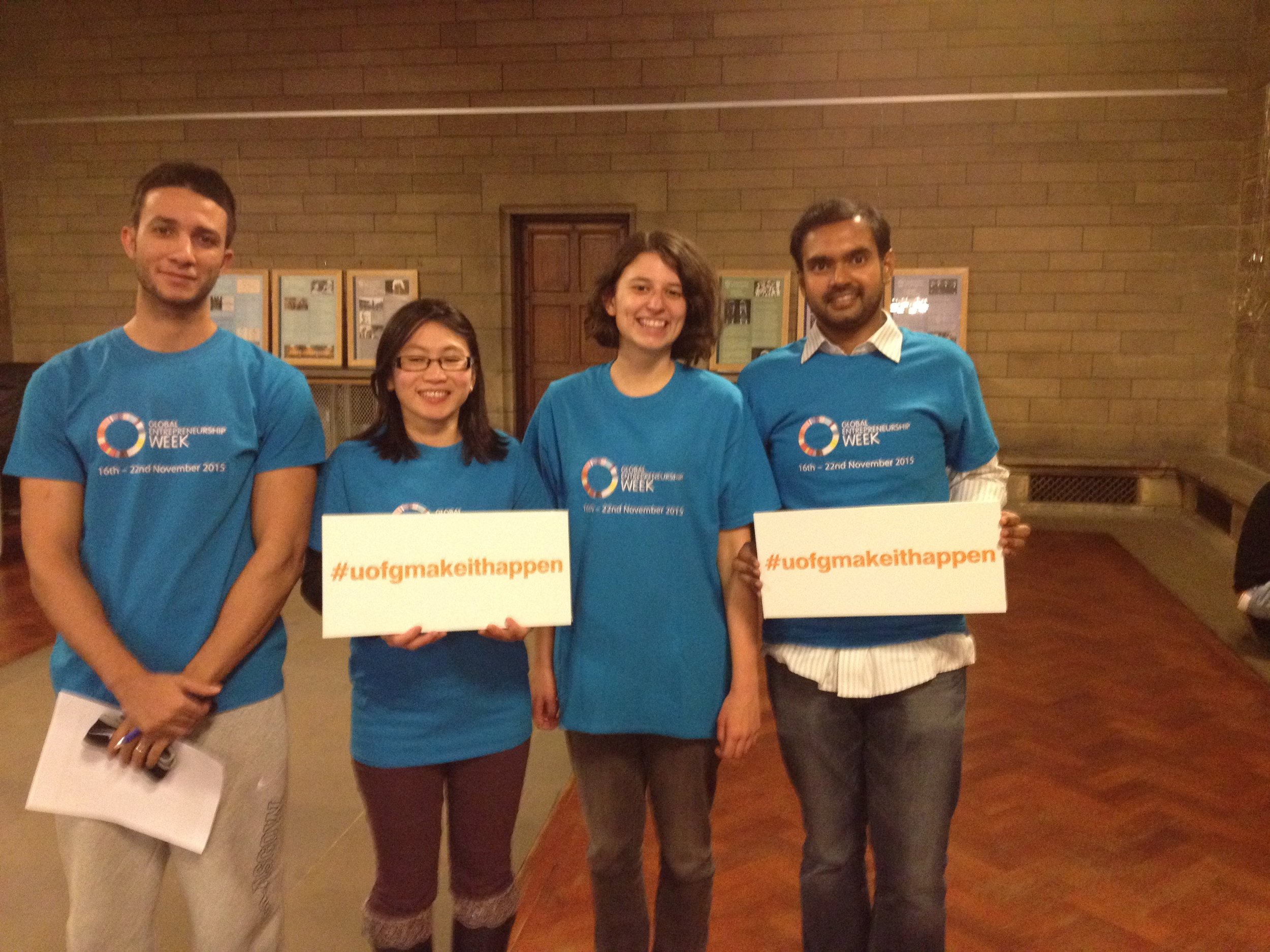 GEW15 volunteers wearing the bright blue branded T-shirts and signs displaying the #uofgmakeithappen hashtag