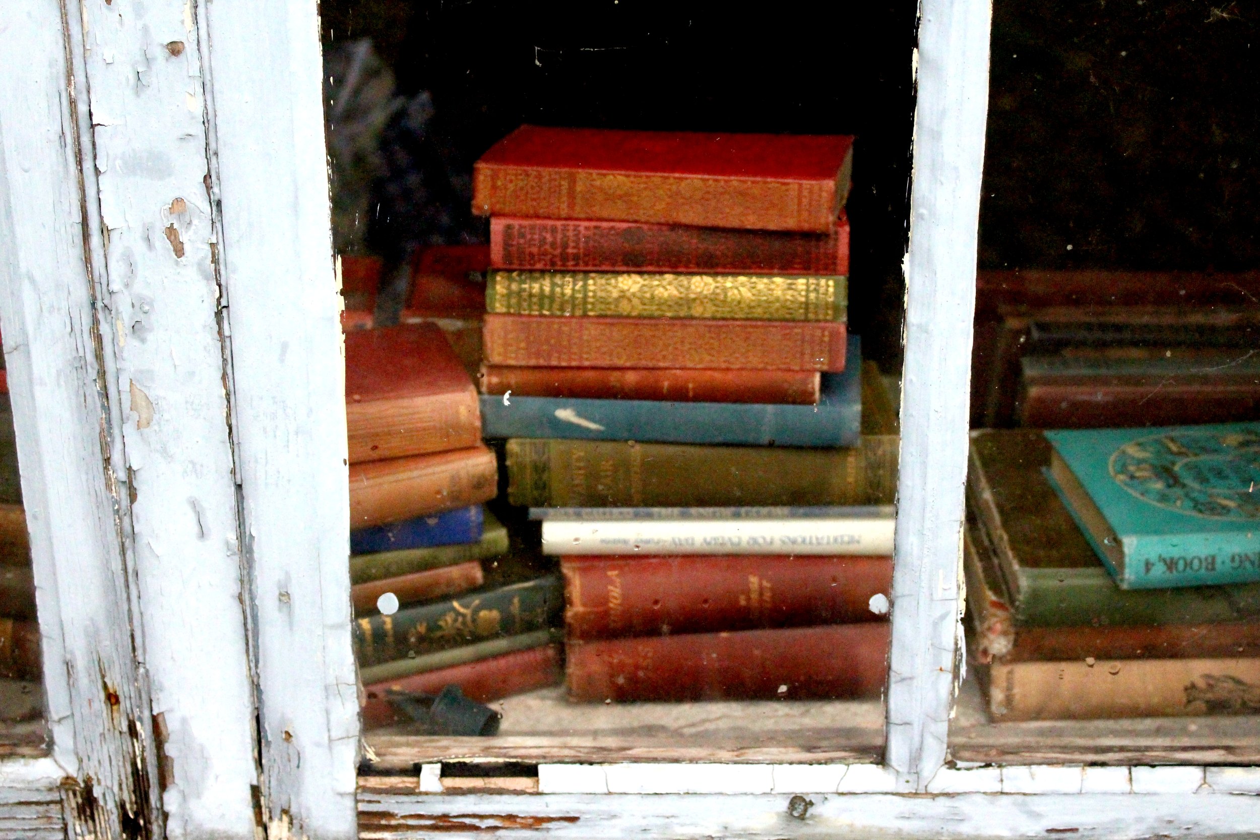 Stacks of books on a window
