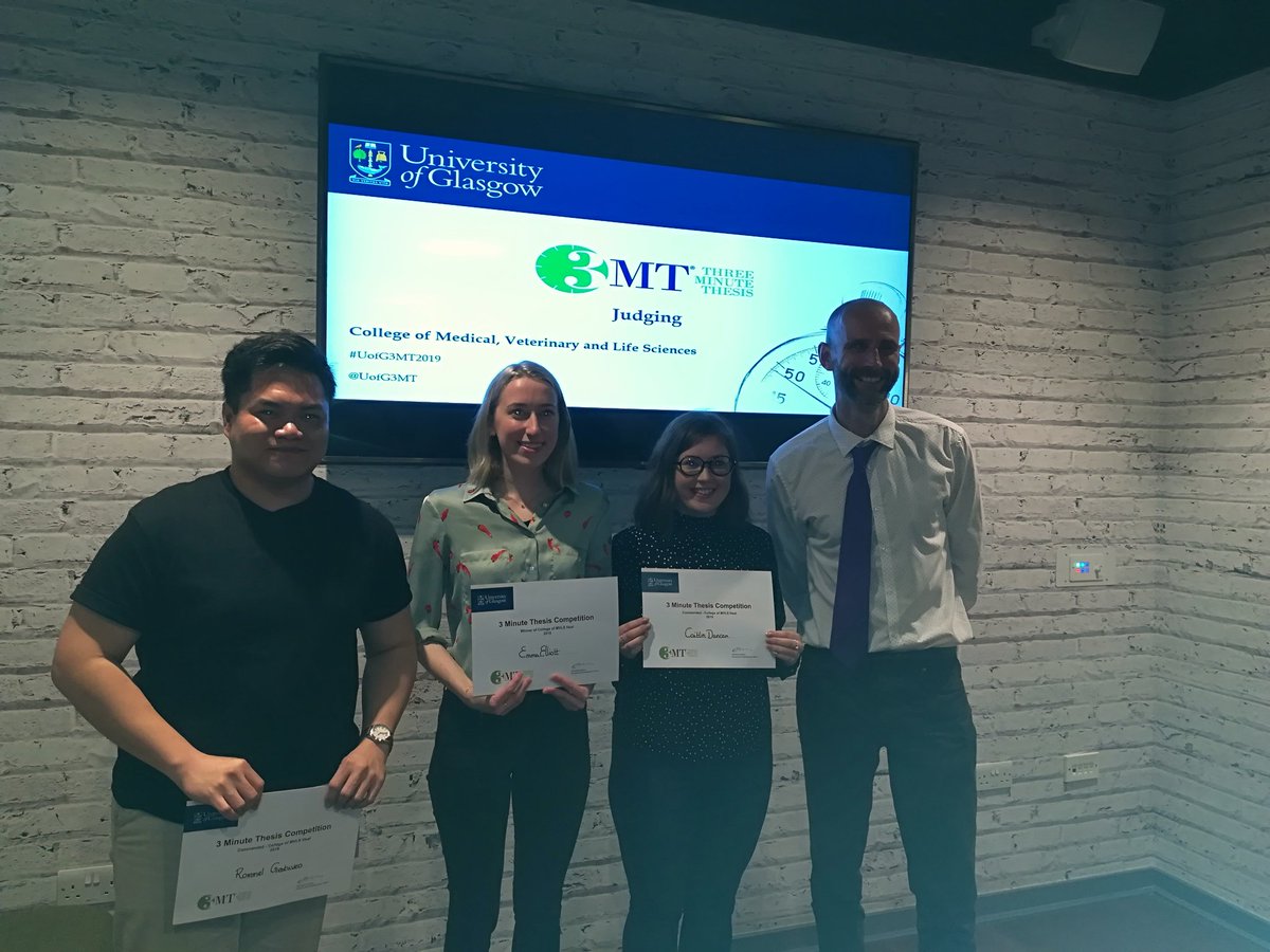 Winner, runners up holding their certificates with a judge off to the side.