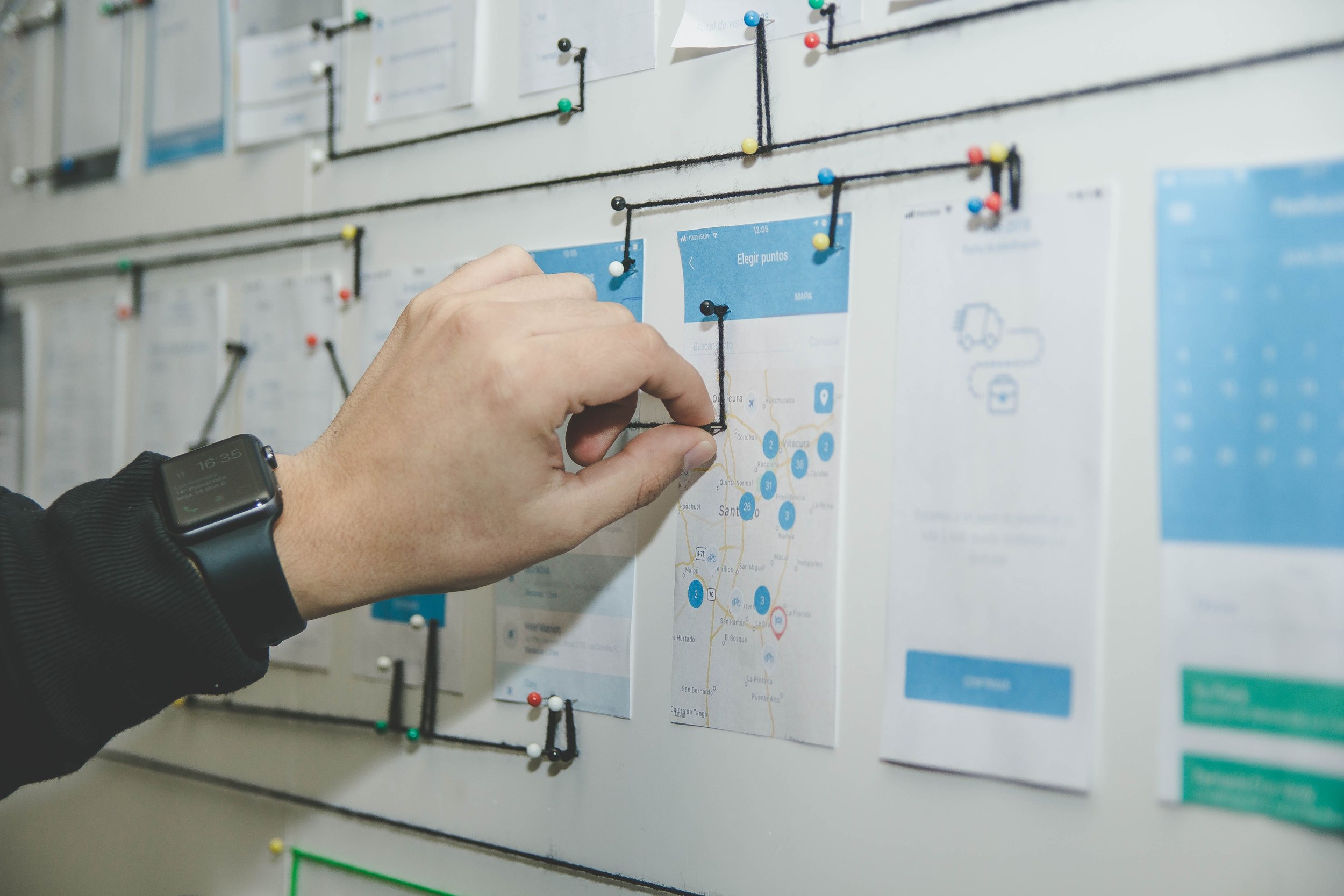 Image of person pinning images to a pin-board