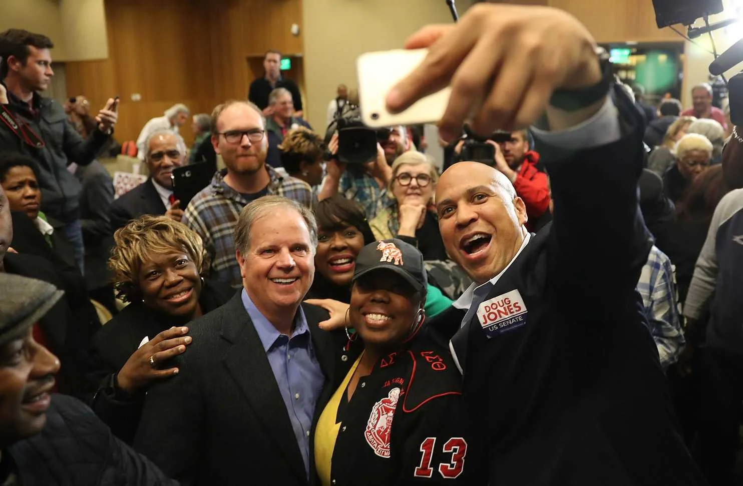 Soon to-be-elected US Sen. Doug Jones (D-Alabama) with women voters who made the upset possible last night, and Sen. Cory Booker (D-New Jersey) campaigning in Alabama—where Roy Moore was soundly defeated despite Steve Bannon and Donald Trump campaigning for the accused girl-stalker. 