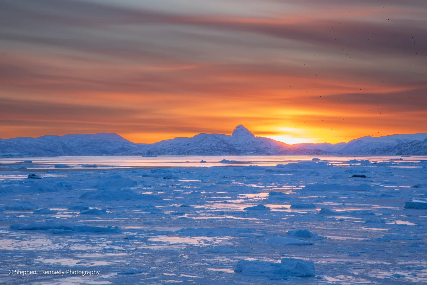 Uummannaq — red sunrise over the frozen fjord