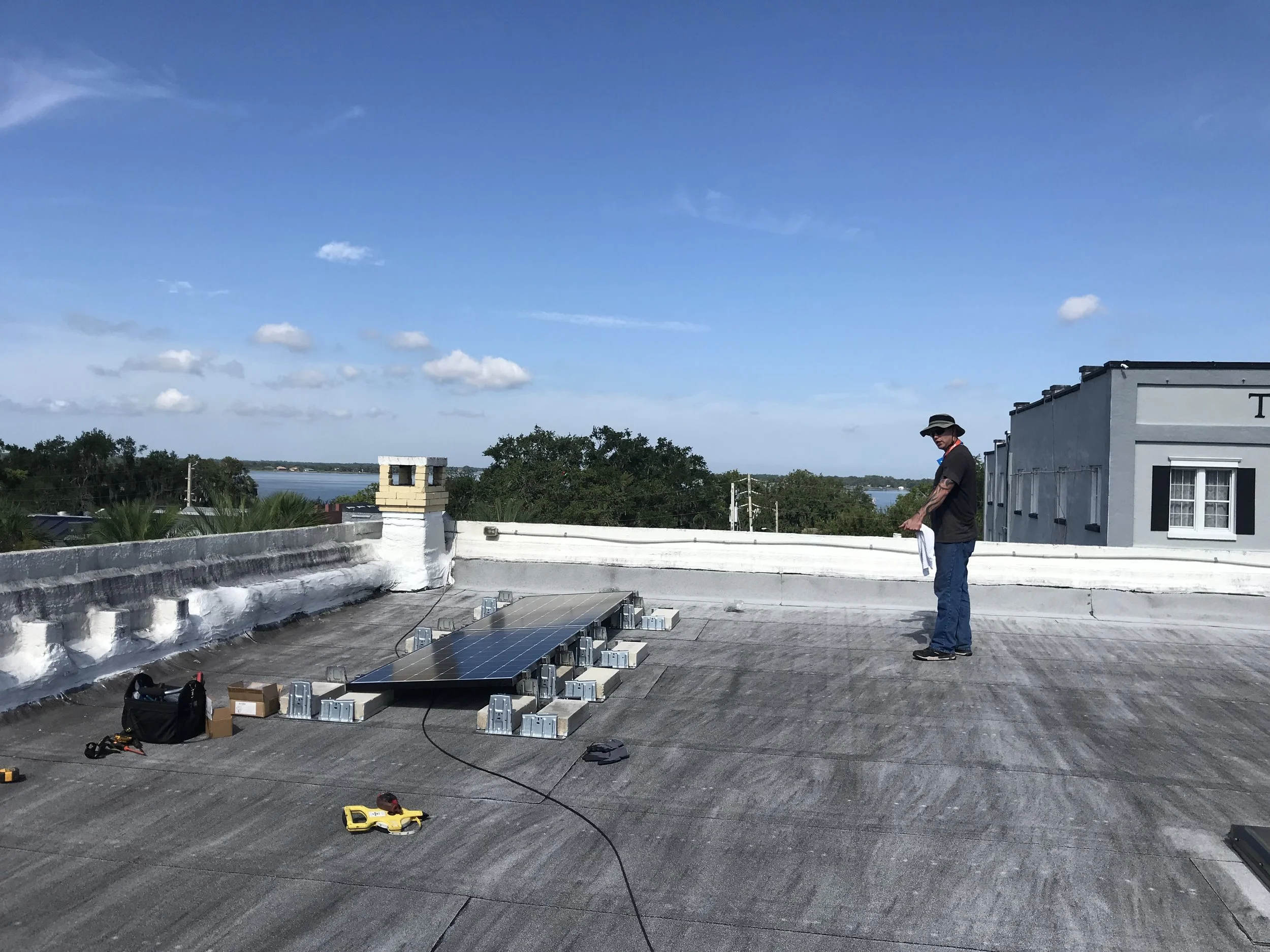 Beginning the Solar PV installation on 402 Donnelly. Lake Dora in the background.
